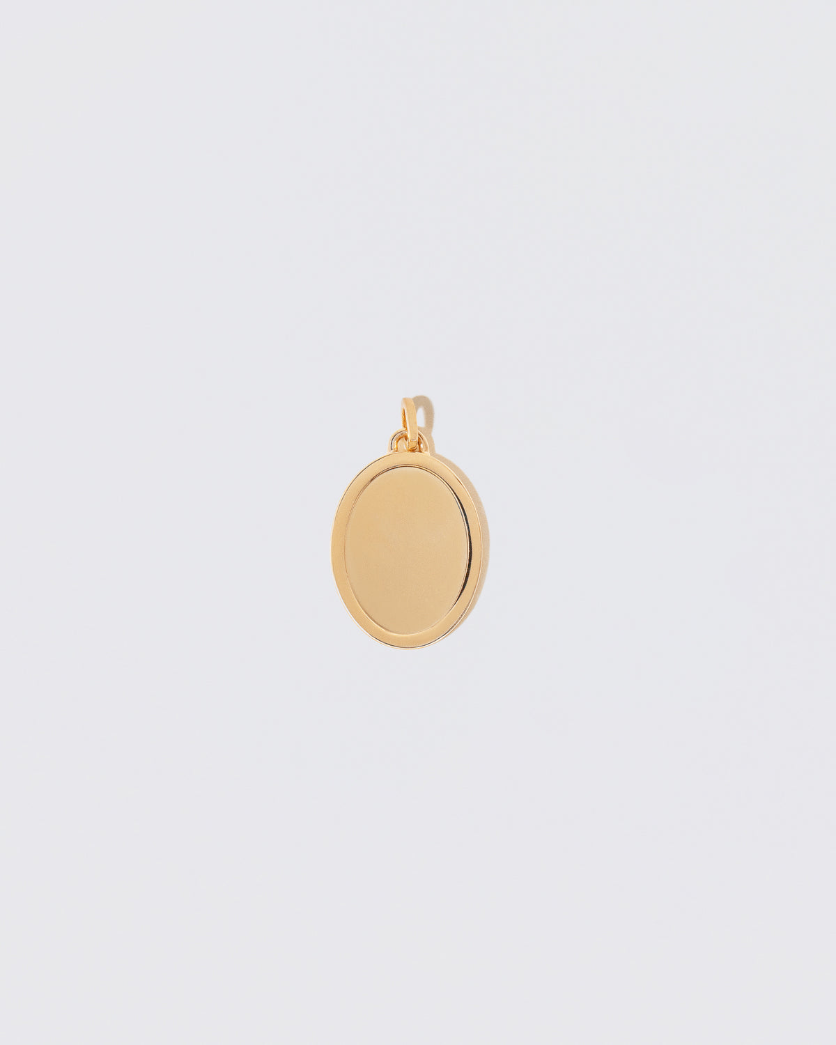 Unfinished Large Oval Pendant Memento Pendant on light color background.