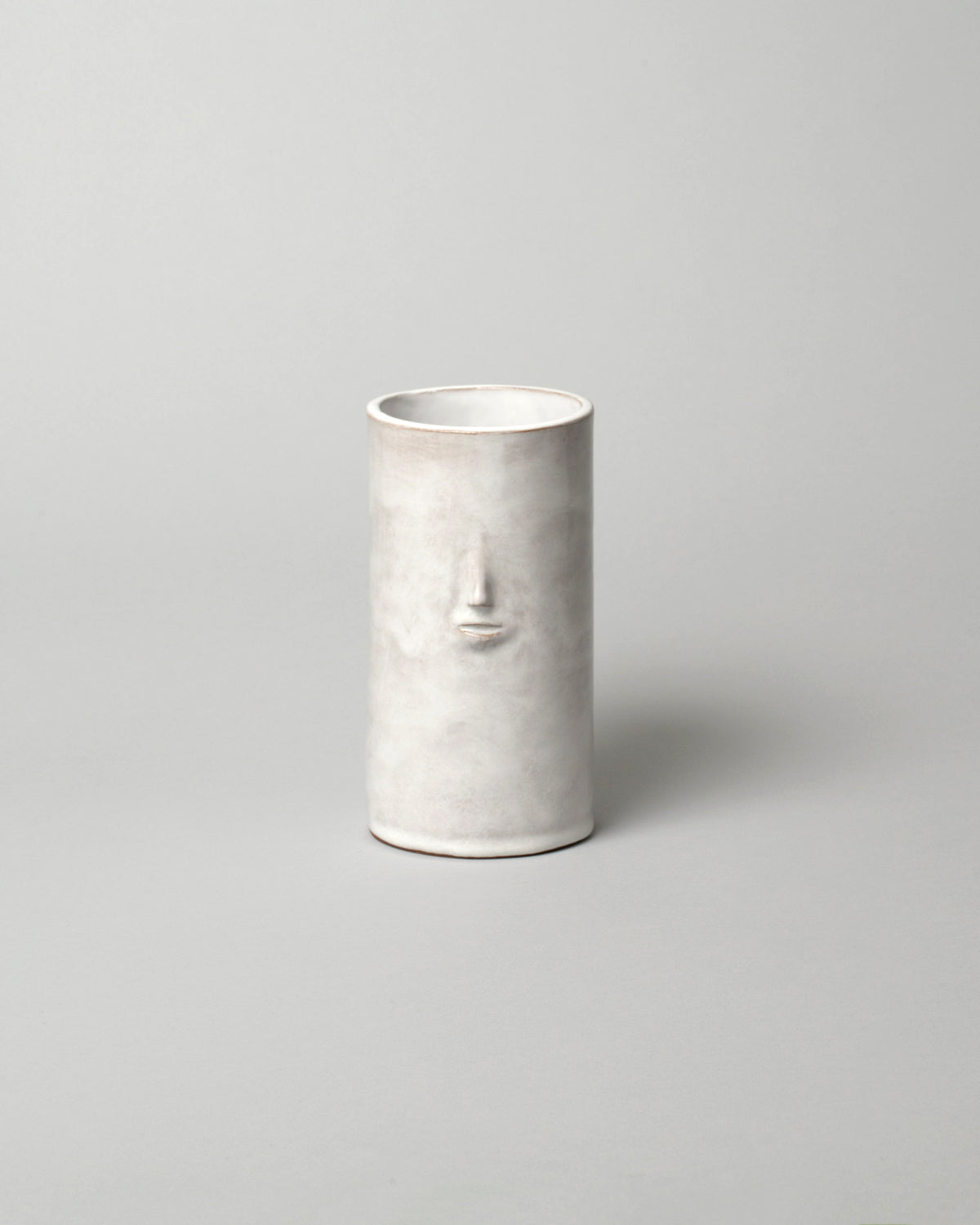 Rami Kim Glossy White Face Vase on light color background.