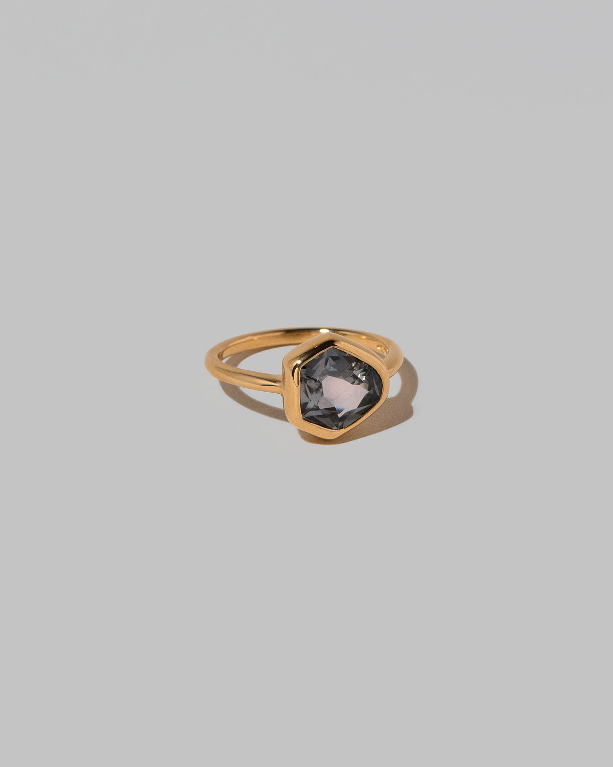 View from the side of the Geyser Purple Sapphire Ring 003 on light color background.