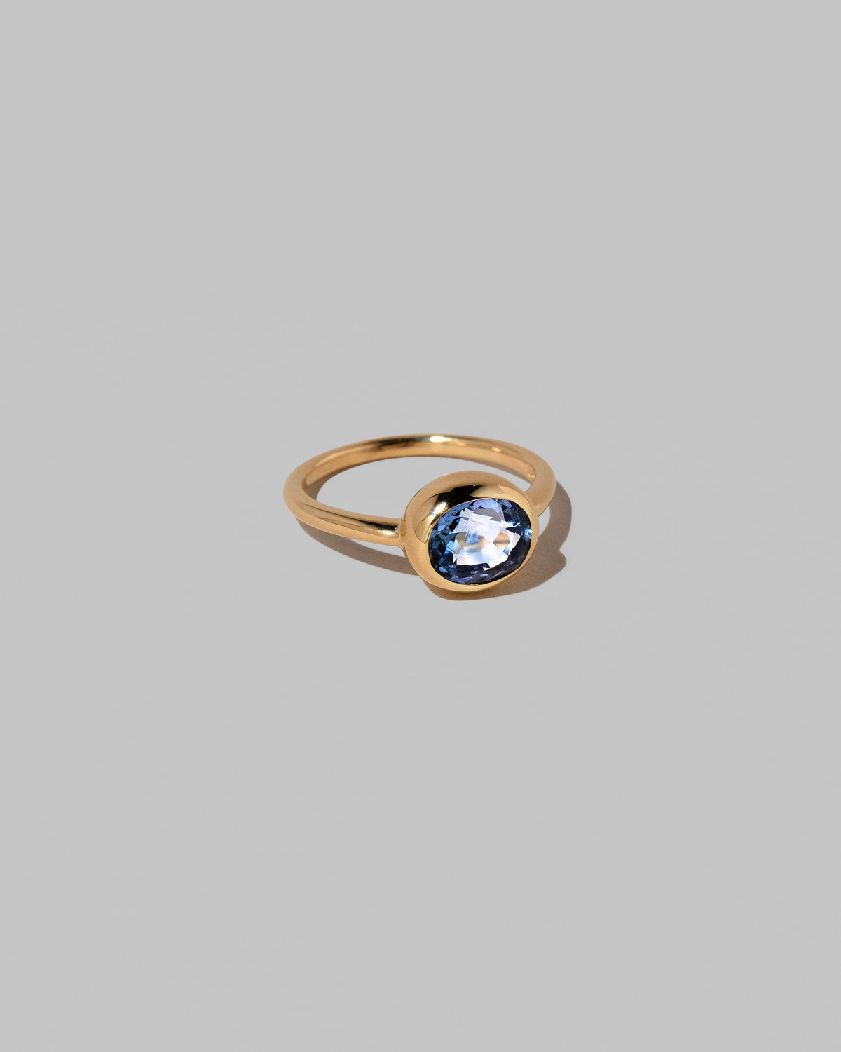 View from the side of the Geyser Blue Sapphire Ring 002 on light color background.