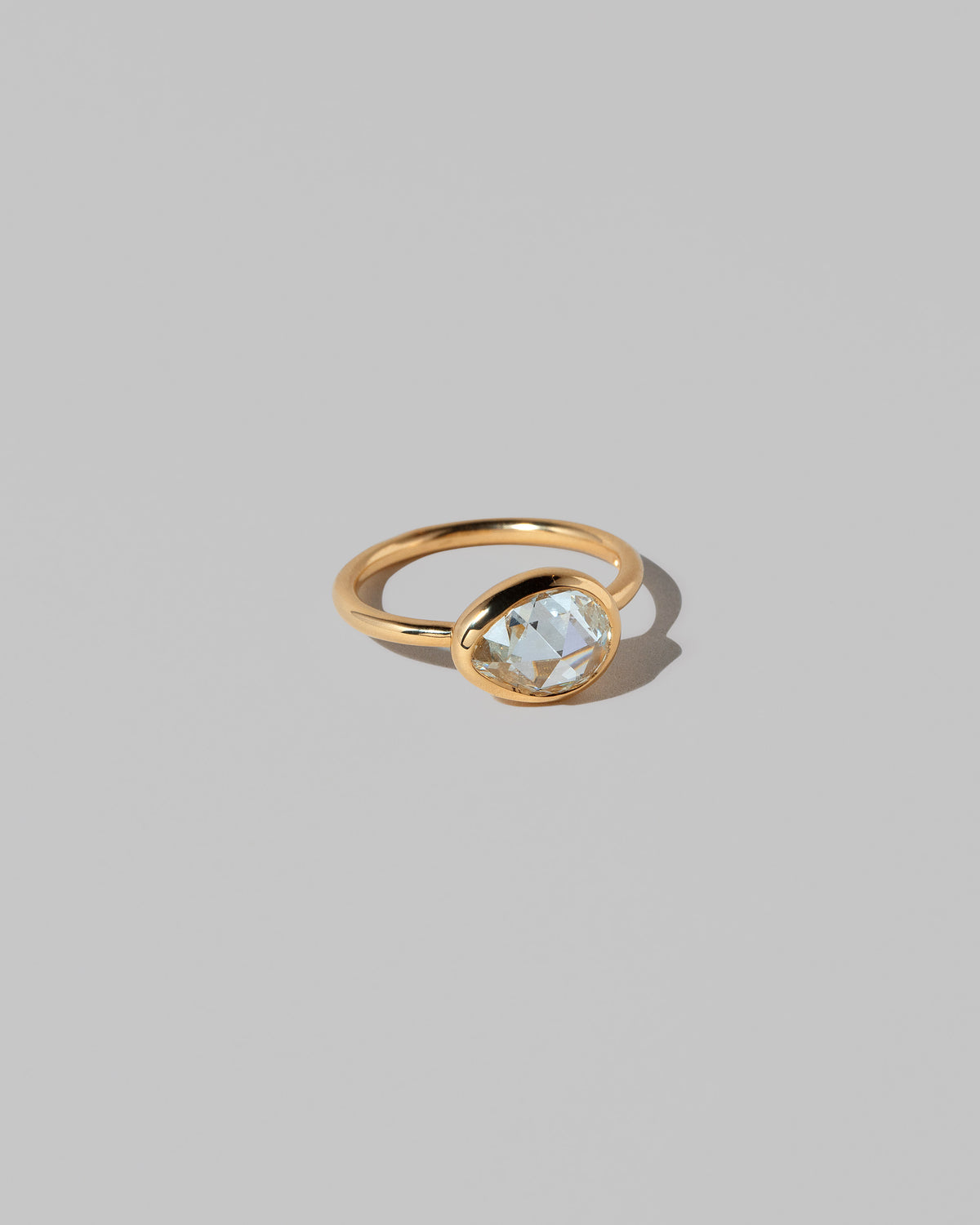View from the side of the Gusher Diamond Ring 027 on light color background.