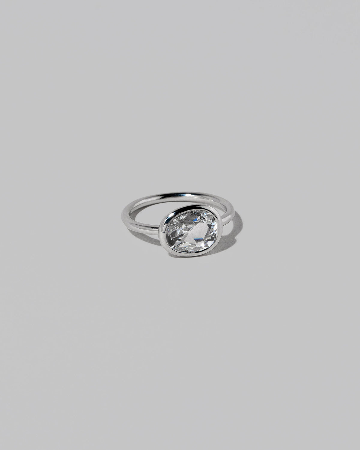 View from the side of the Gusher Diamond Ring 028 on light color background.