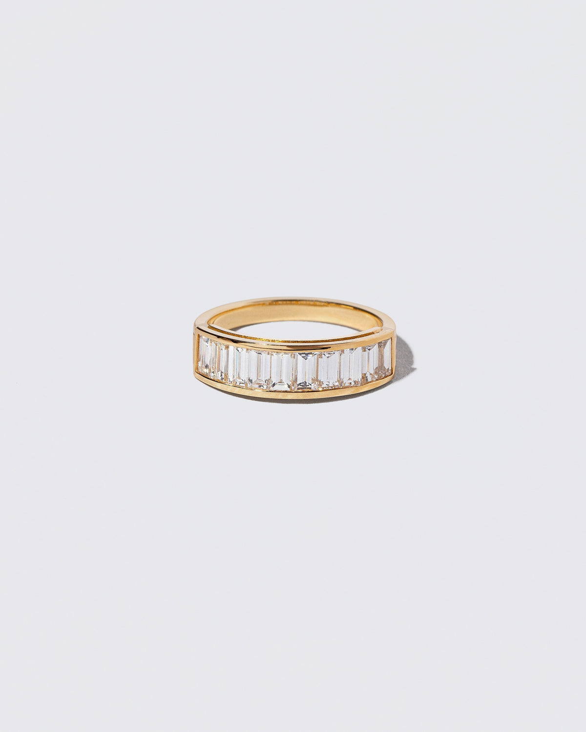 Gold Arcade Ring on light color background.