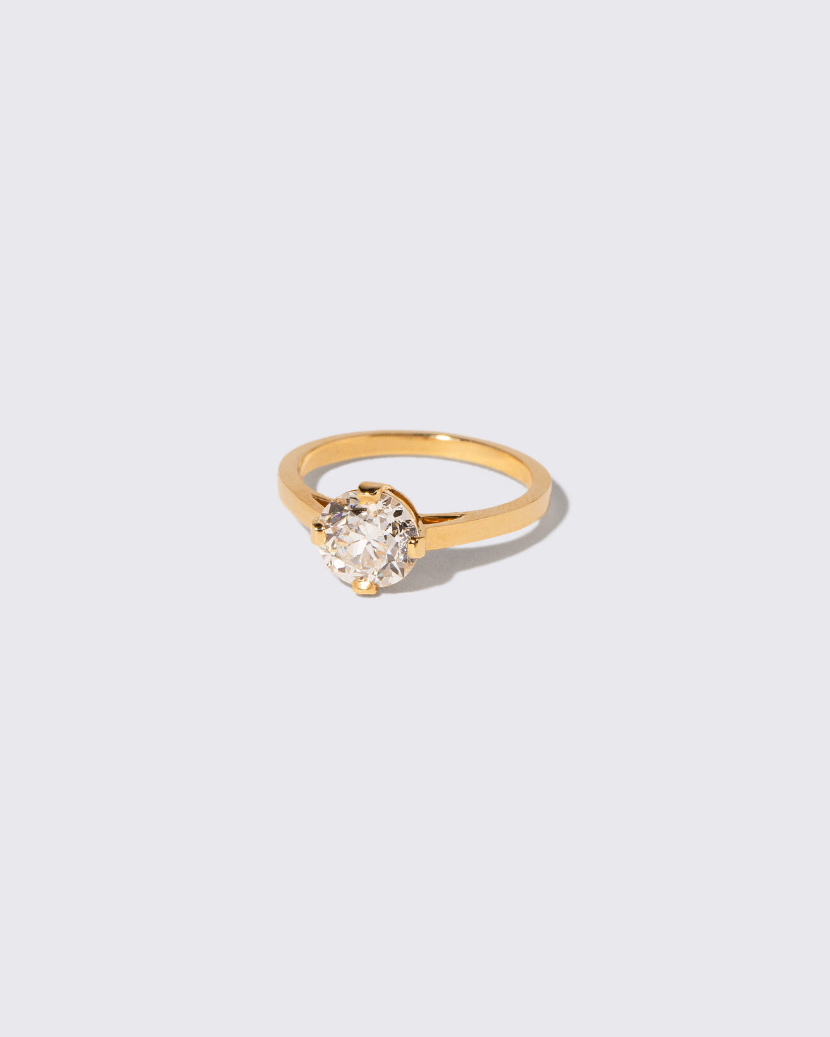 View from the side of the Super White Diamond Barragán Ring on light color background.