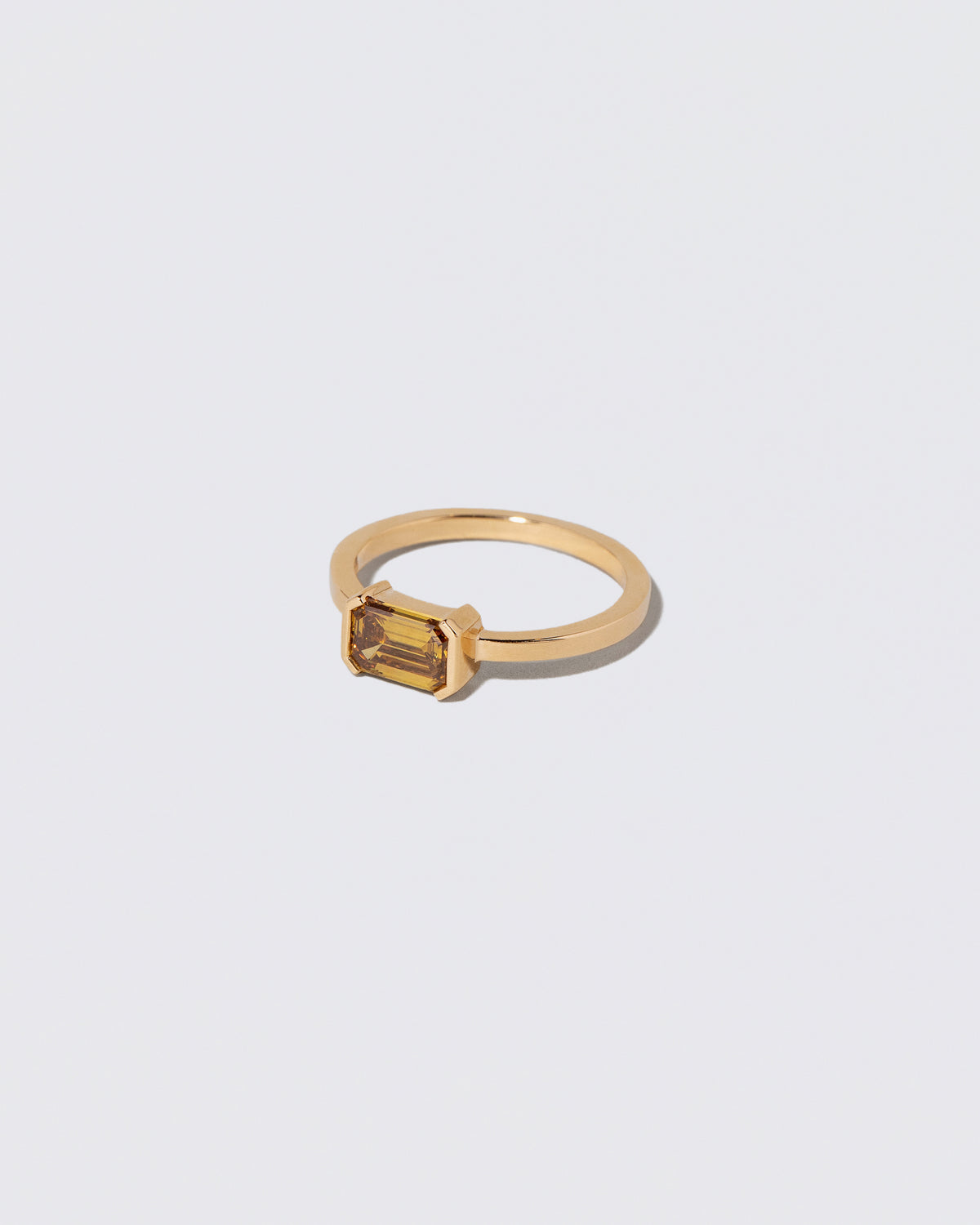 View from the side of the Brown Diamond Courtship Ring on light color background.