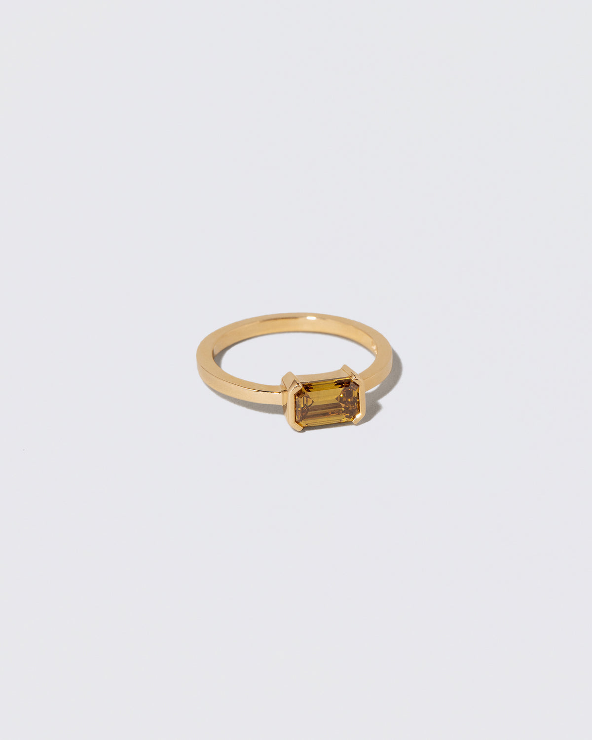 View from the side of the Brown Diamond Courtship Ring on light color background.