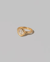 View from the side of a past edition of the  Diamond Poise Ring on light color background.