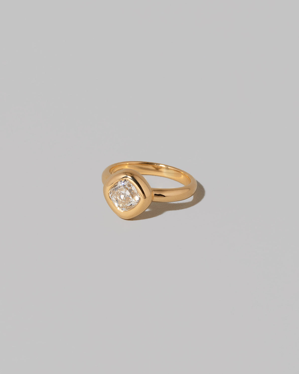 View from the side of a past edition of the  Diamond Poise Ring on light color background.