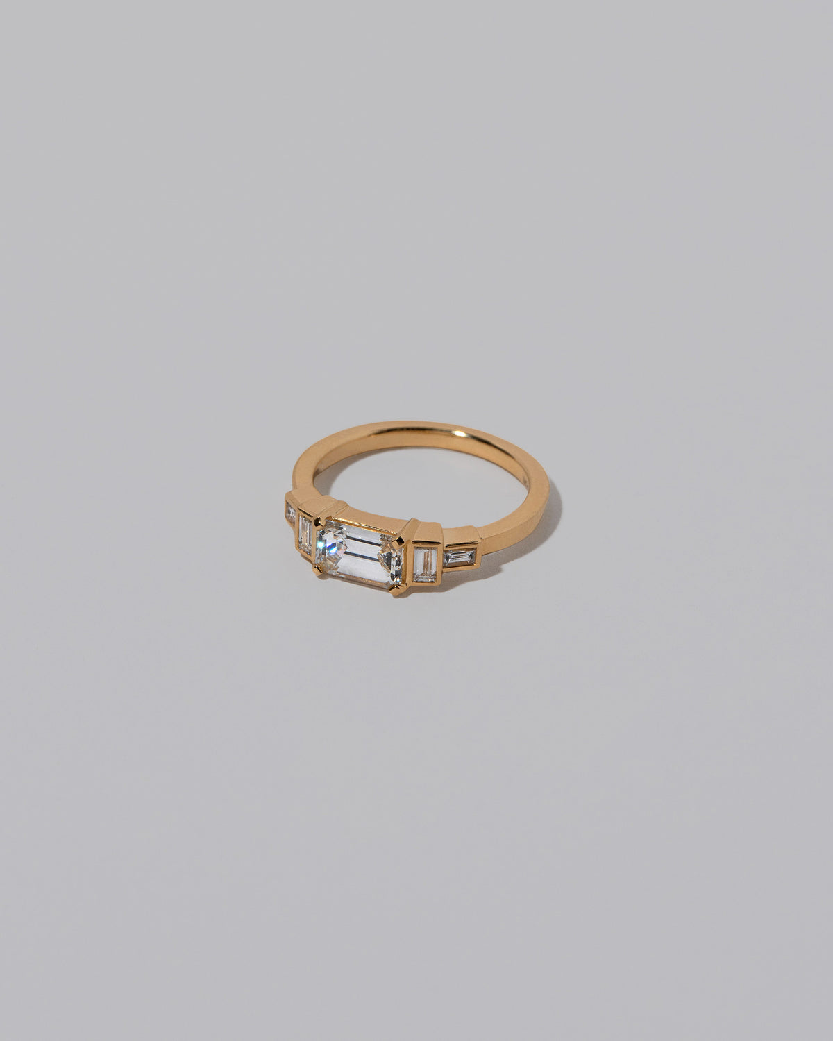 View from the side of the Diamond Expression Ring on light color background.