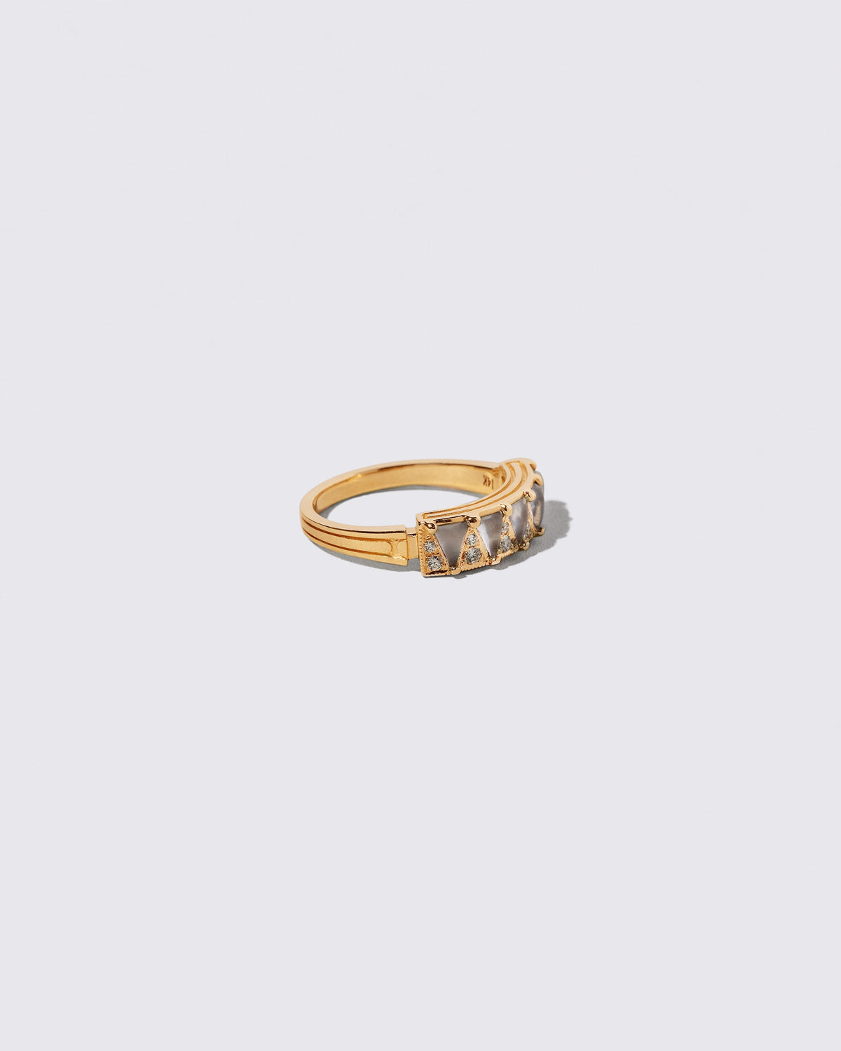 View from the side of the Gold Blue Chalcedony Five Triangle Ring on light color background.