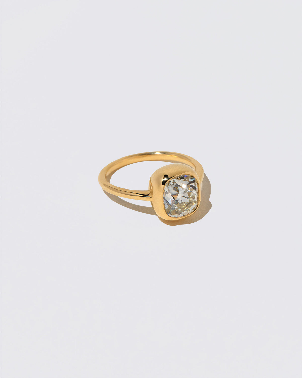 View from the side of the Geyser Diamond Ring 006 on light color background.