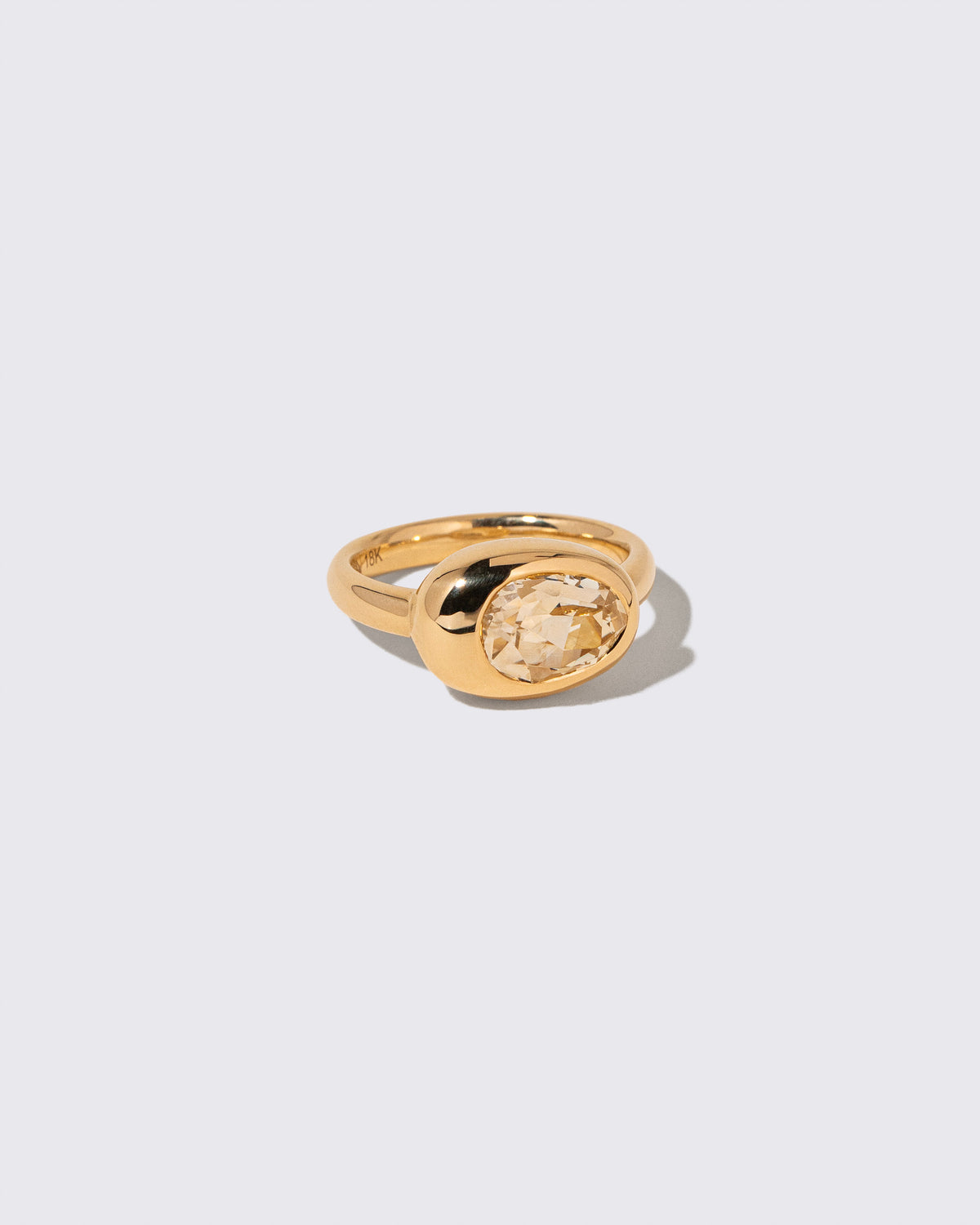 View from the side of the Sapphire Grand Align Ring on light color background.