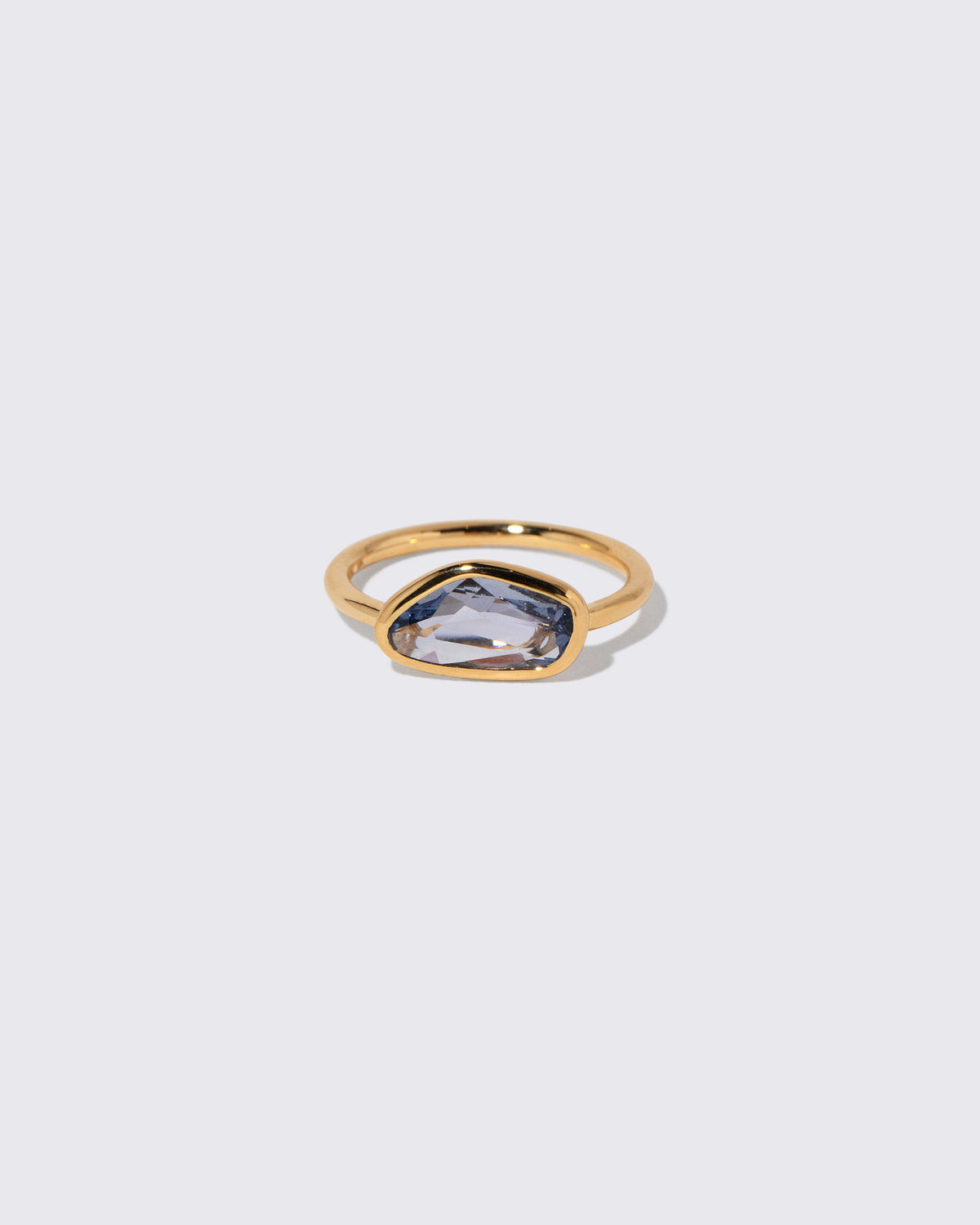 Blue Sapphire Gusher Ring on light color background.
