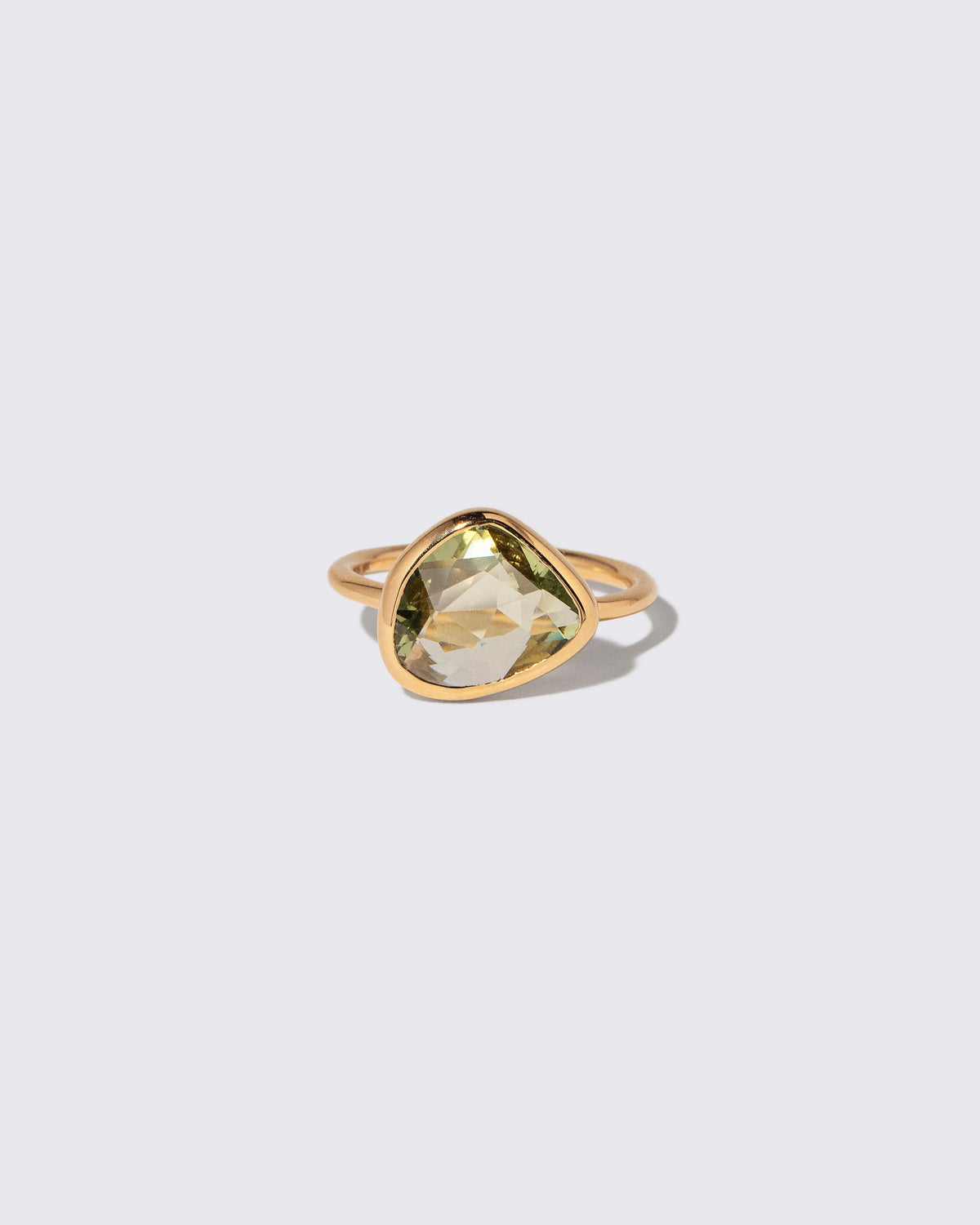 Green Sapphire Gusher Ring on light color background.