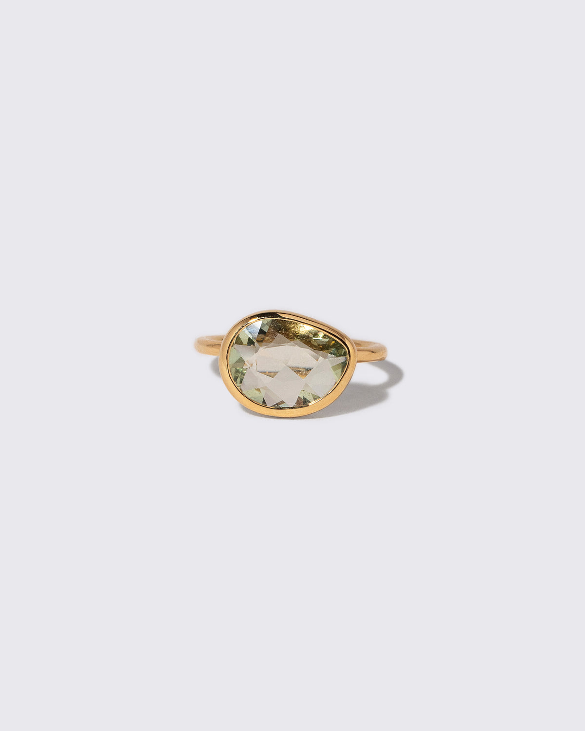 Green Sapphire Gusher Ring on light color background.