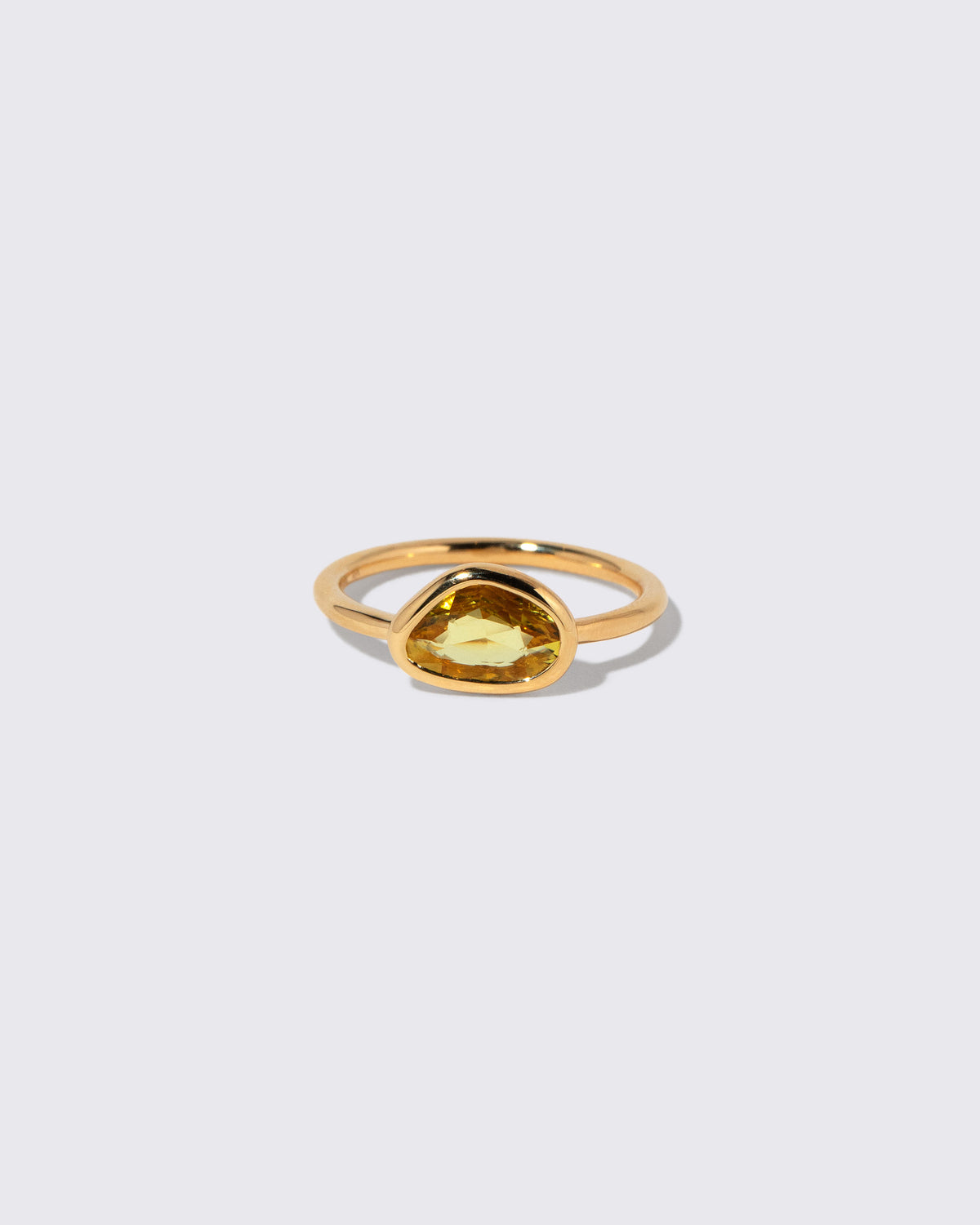 Yellow Sapphire Gusher Ring on light color background.