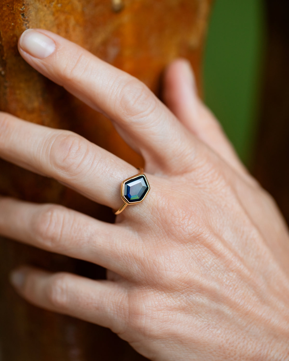Teal Blue Sapphire Gusher Ring on model.