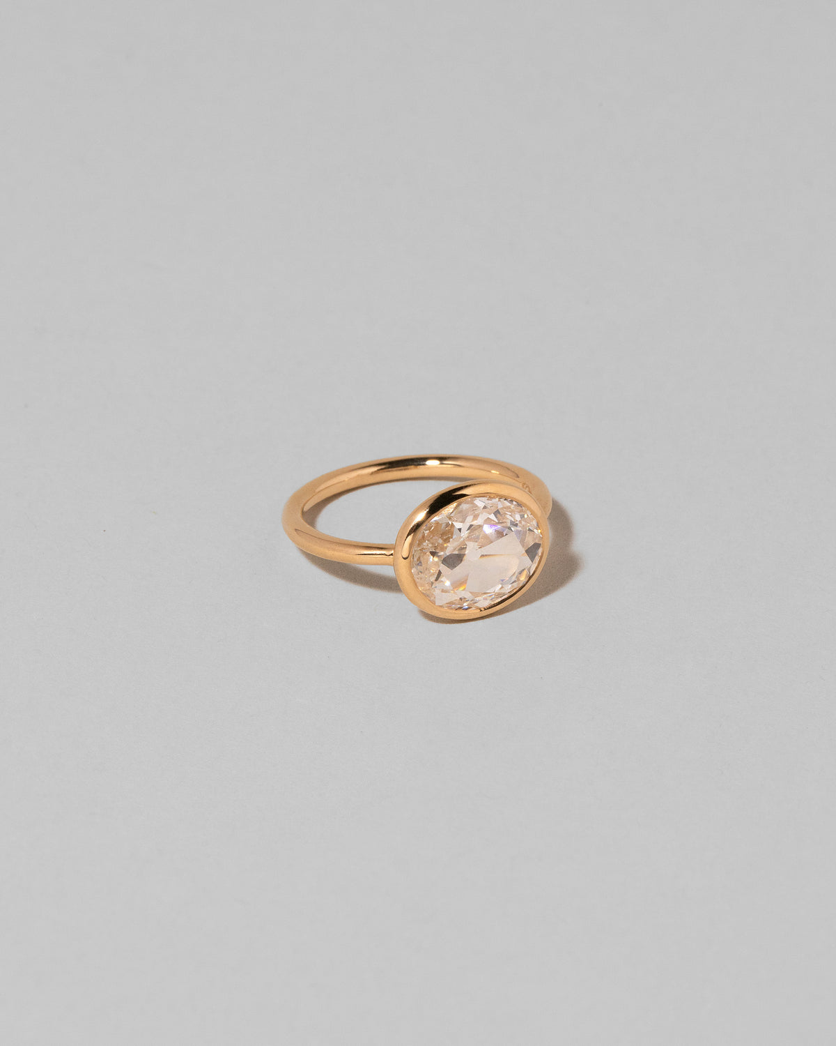 View from the side of the Gusher Diamond Ring 001 on light color background.