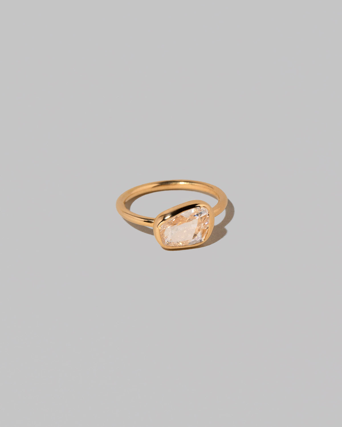 View from the side of the Gusher Diamond Ring 016 on light color background.