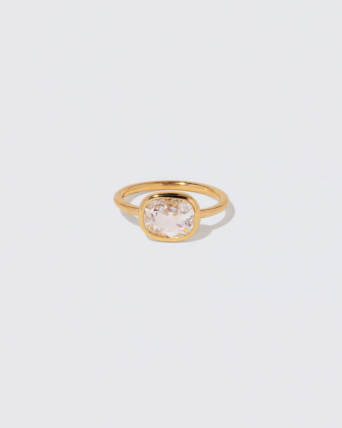 Cushion Diamond Gusher Ring on light color background.