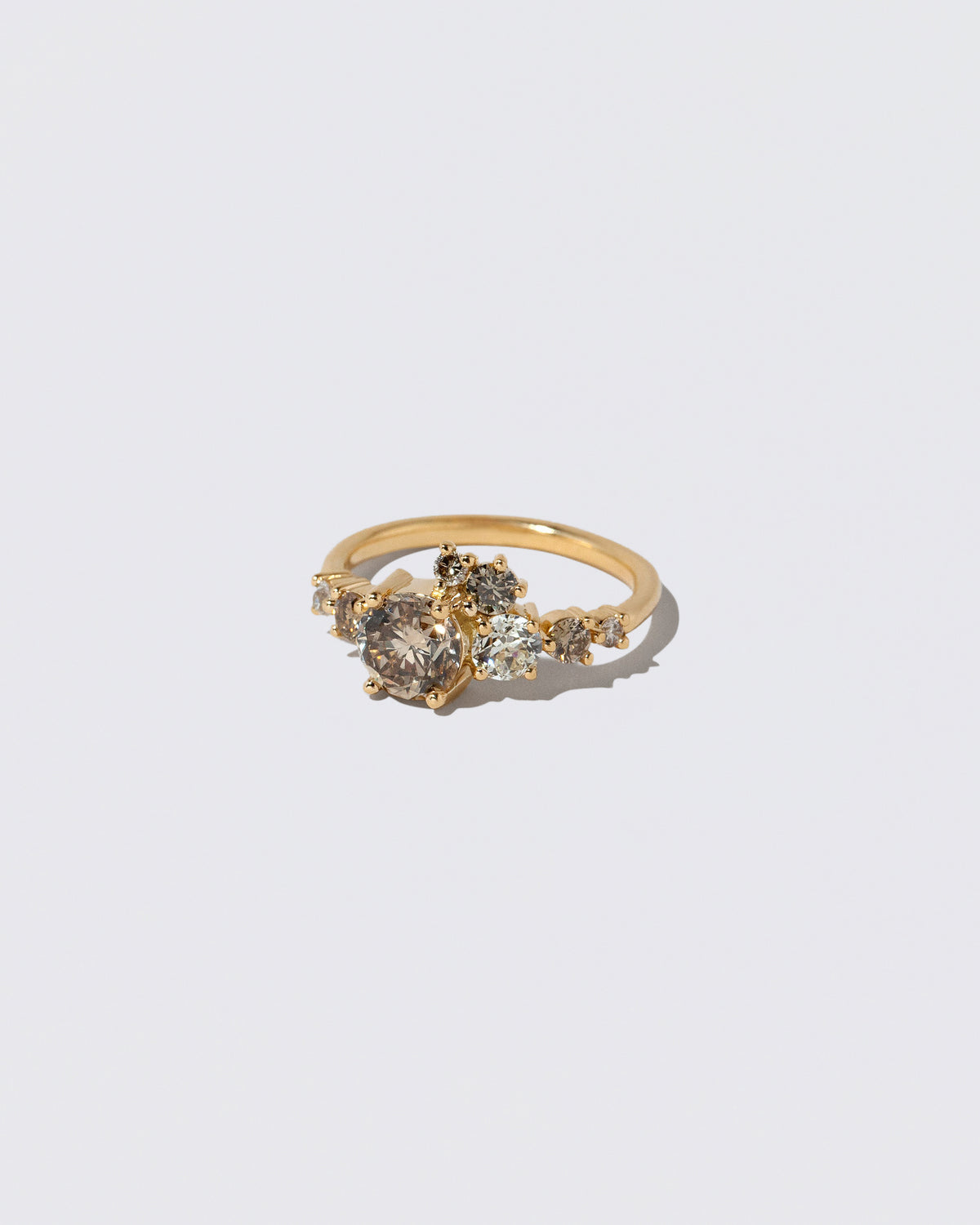 View from the side of the Champagne Diamond Luna Ring on light color background.