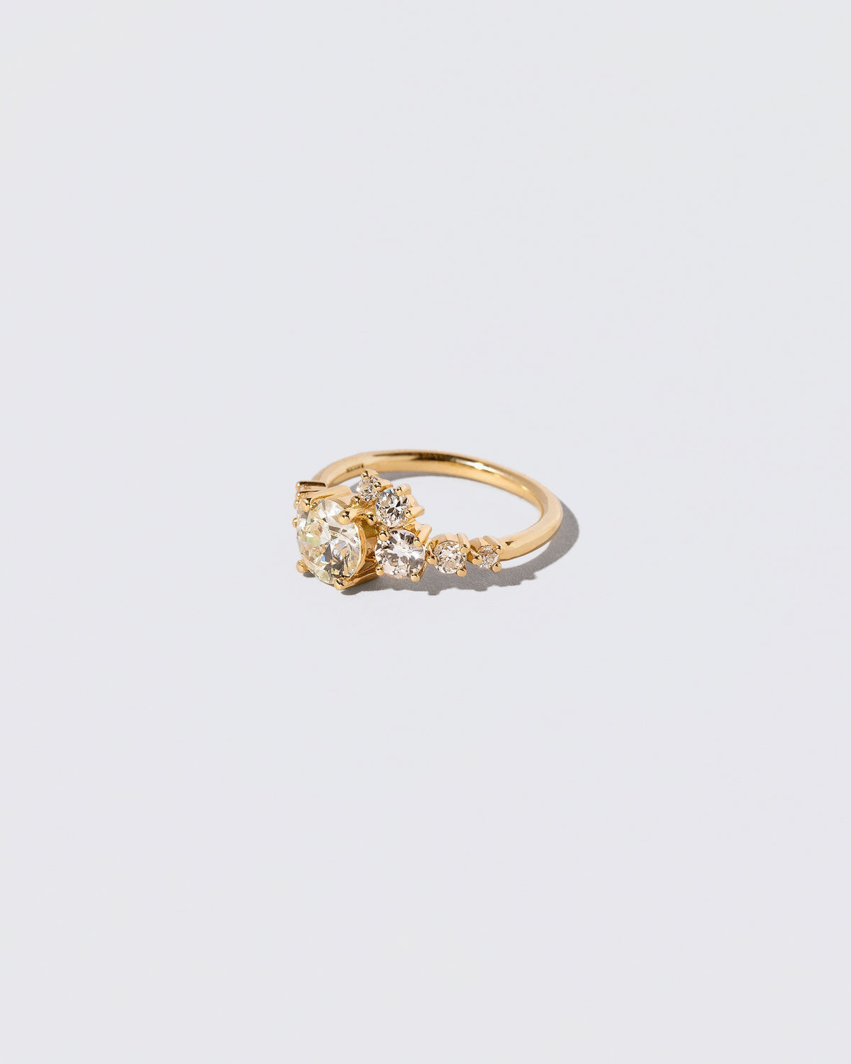 View from the side of the White Diamond Luna Ring on light color background.