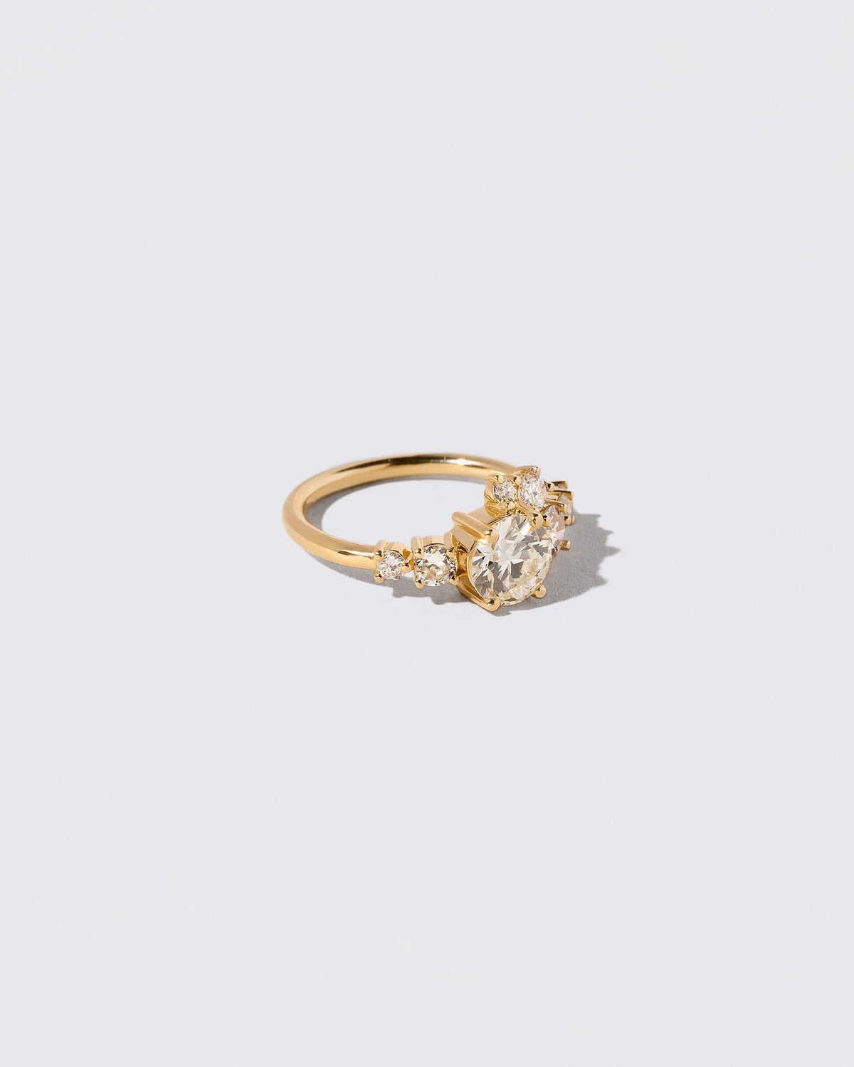 View from the side of the White Diamond Luna Ring on light color background.
