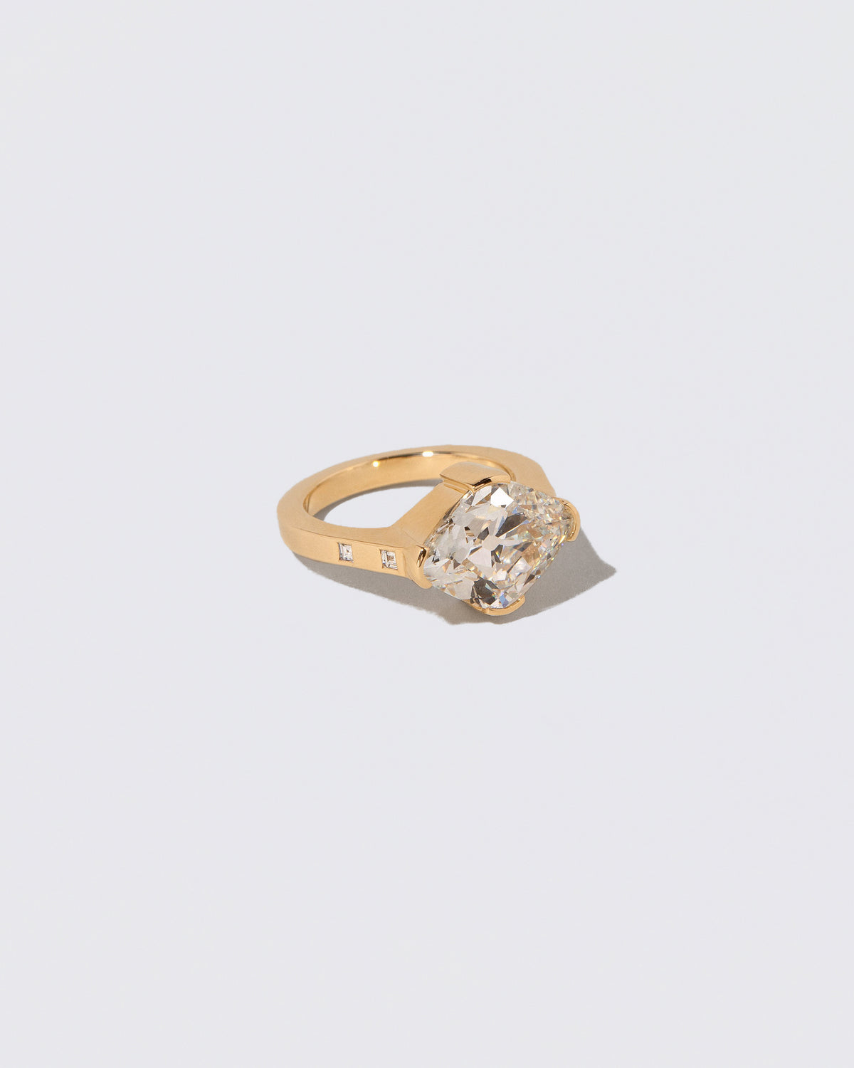 View from the side of the Narcissus Ring on light color background.