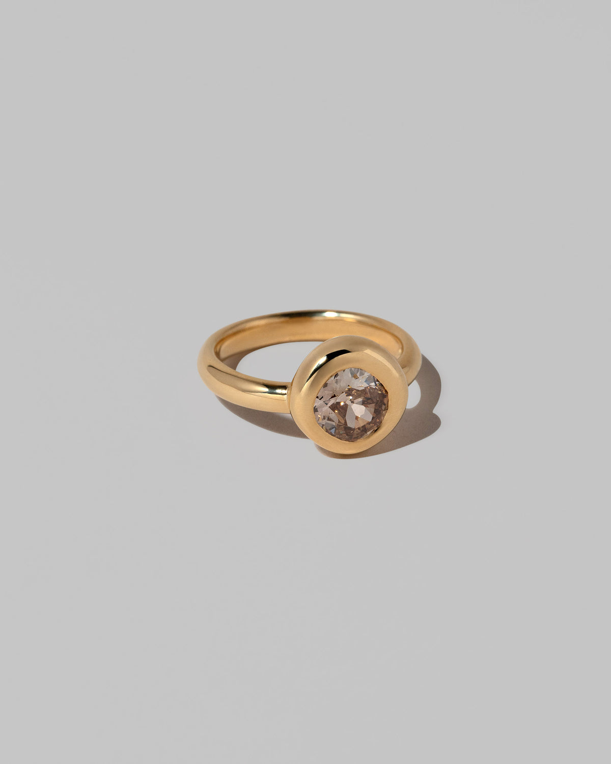 View from the side of the Brown Diamond Poise Ring on light color background.