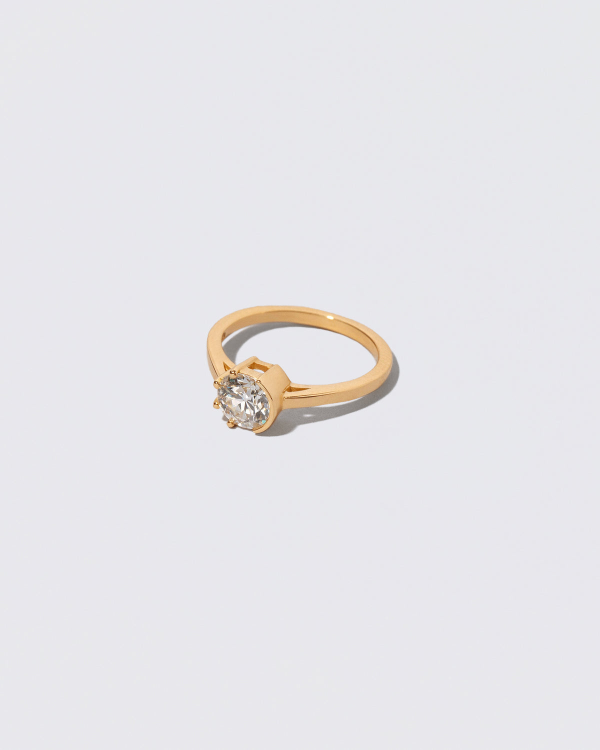 View from the side of the White Diamond Sun & Moon Ring on light color background.