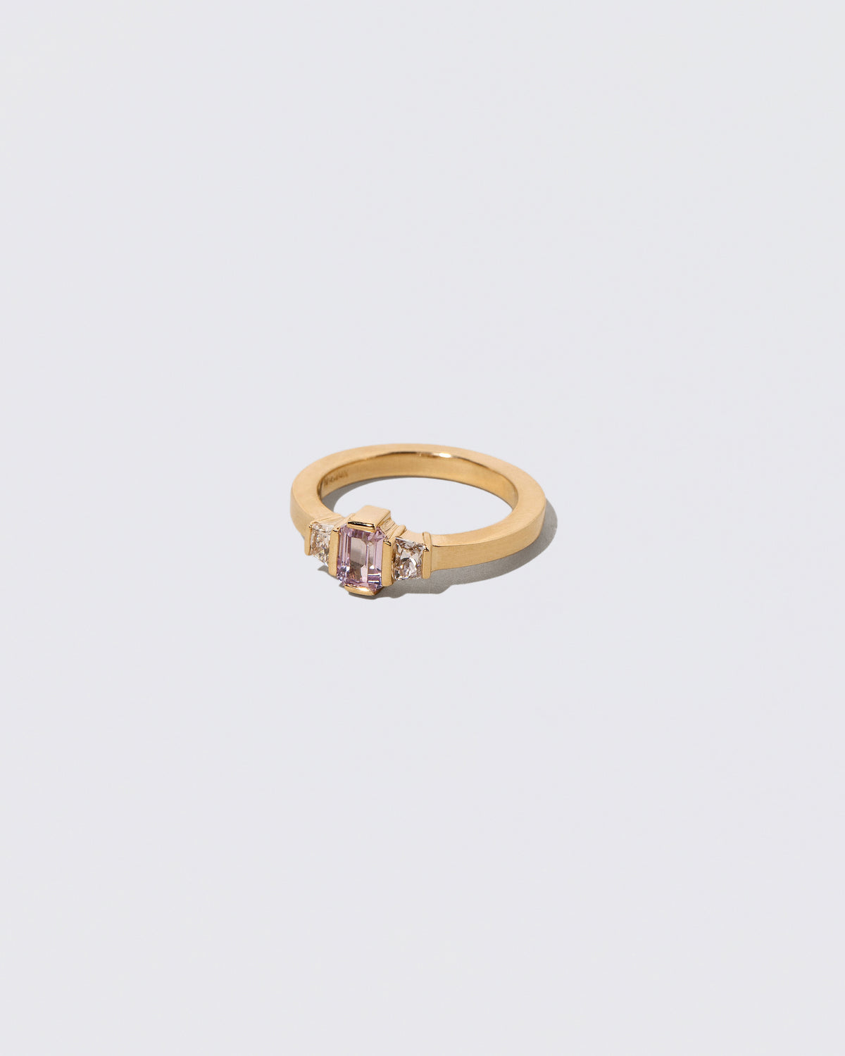View from the side of the Sweetheart Ring on light color background.