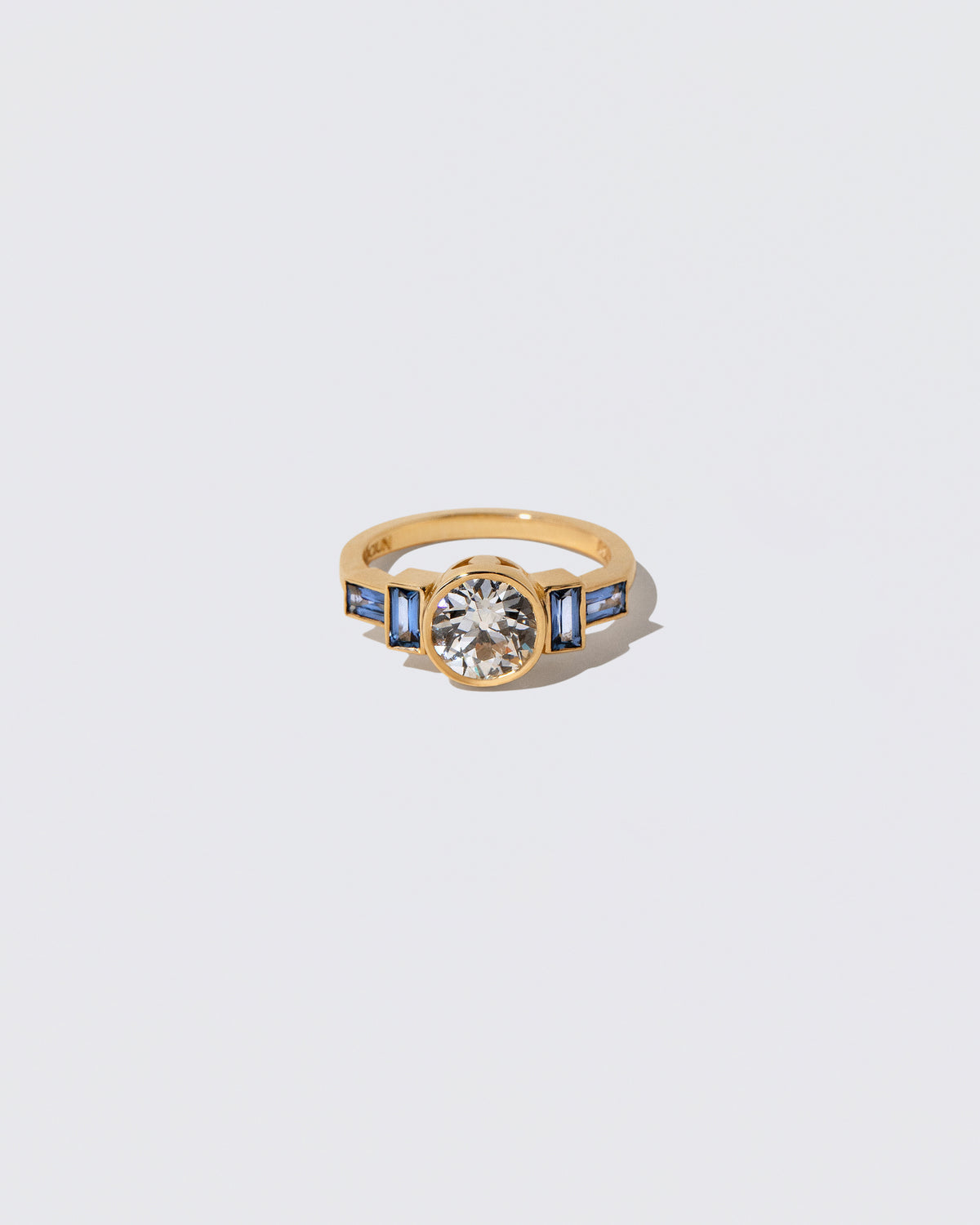 White Diamond & Blue Sapphire Third Eye Ring on light color background.