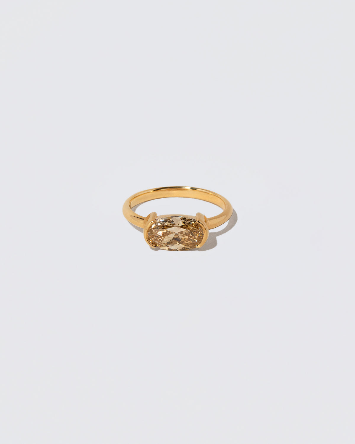 Oval Brown Diamond Transformation Ring on light color background.