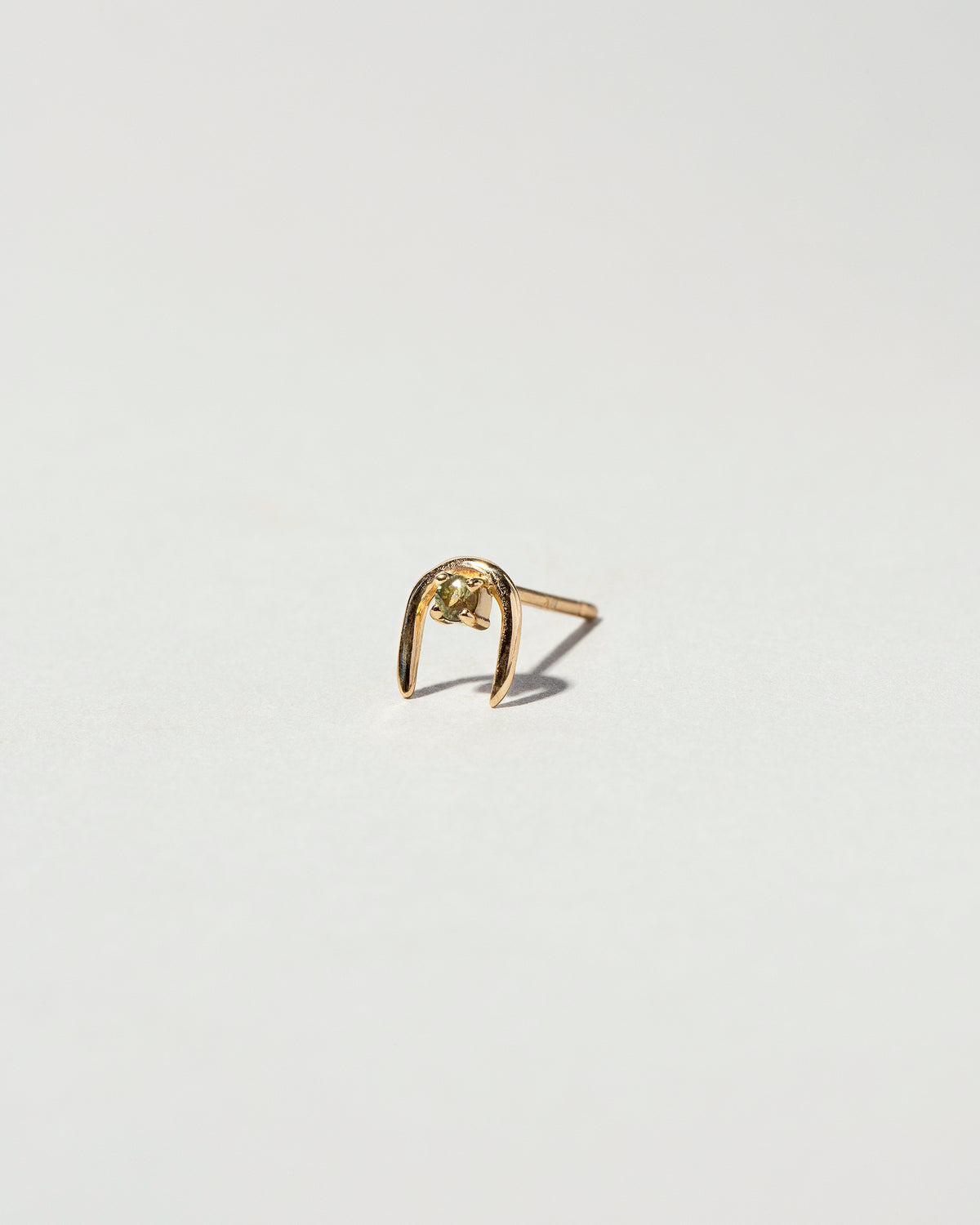 Peridot Moon Catcher Stud Earring Single on light color background.