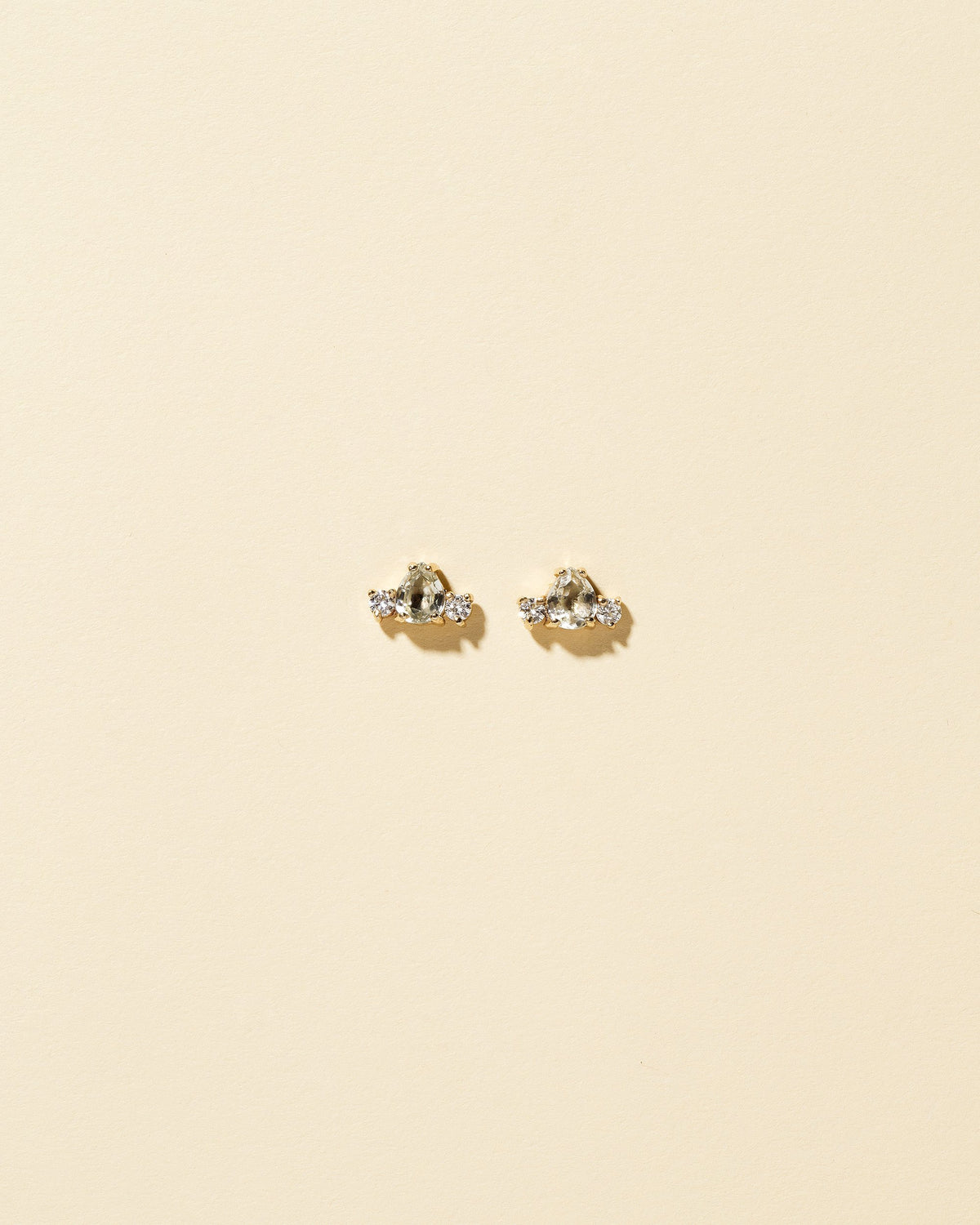 Tourmaline & Diamond Teardrop Earrings on light color background.
