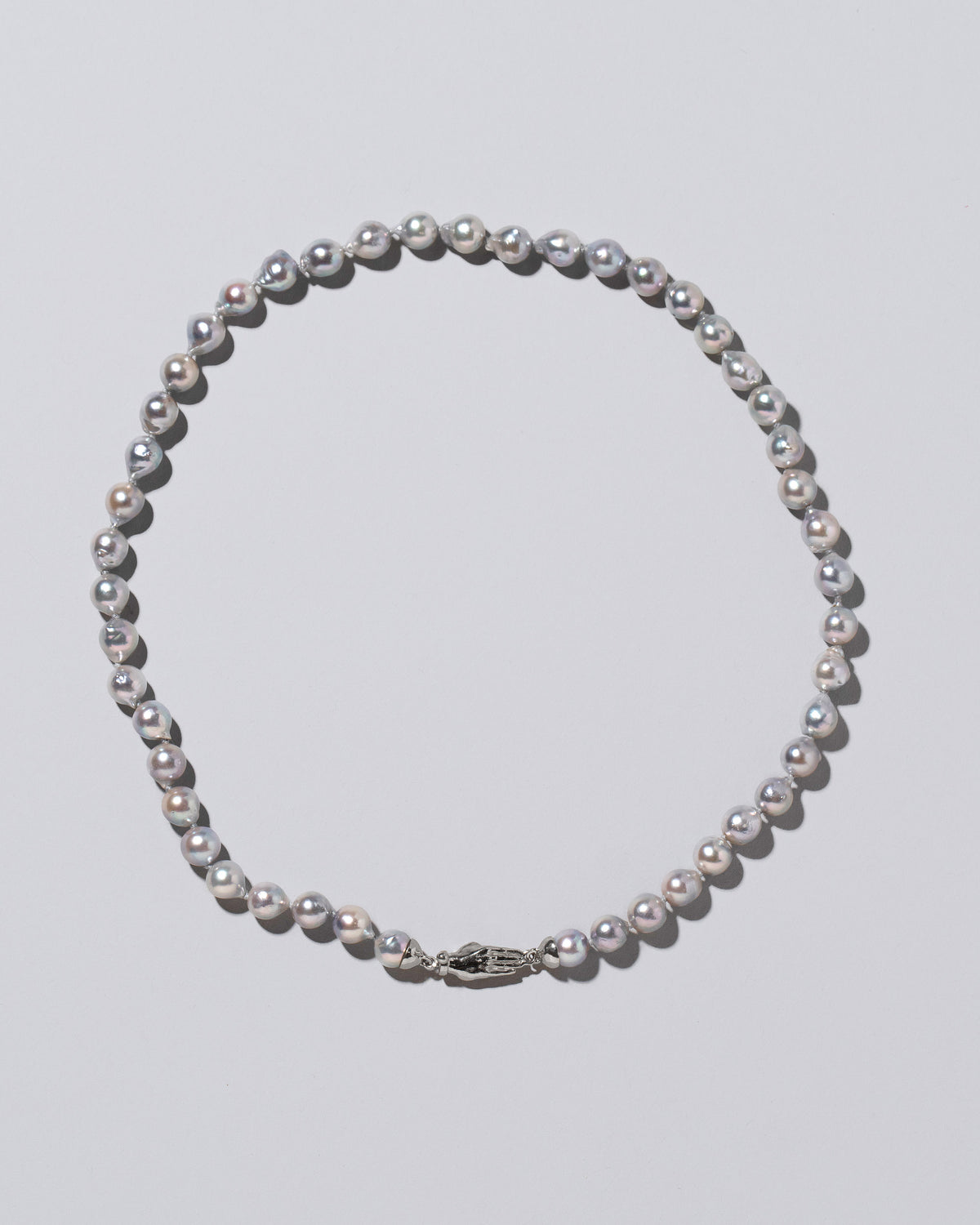 Blue Pearl & White Gold Union Pearl Necklace on light color background.