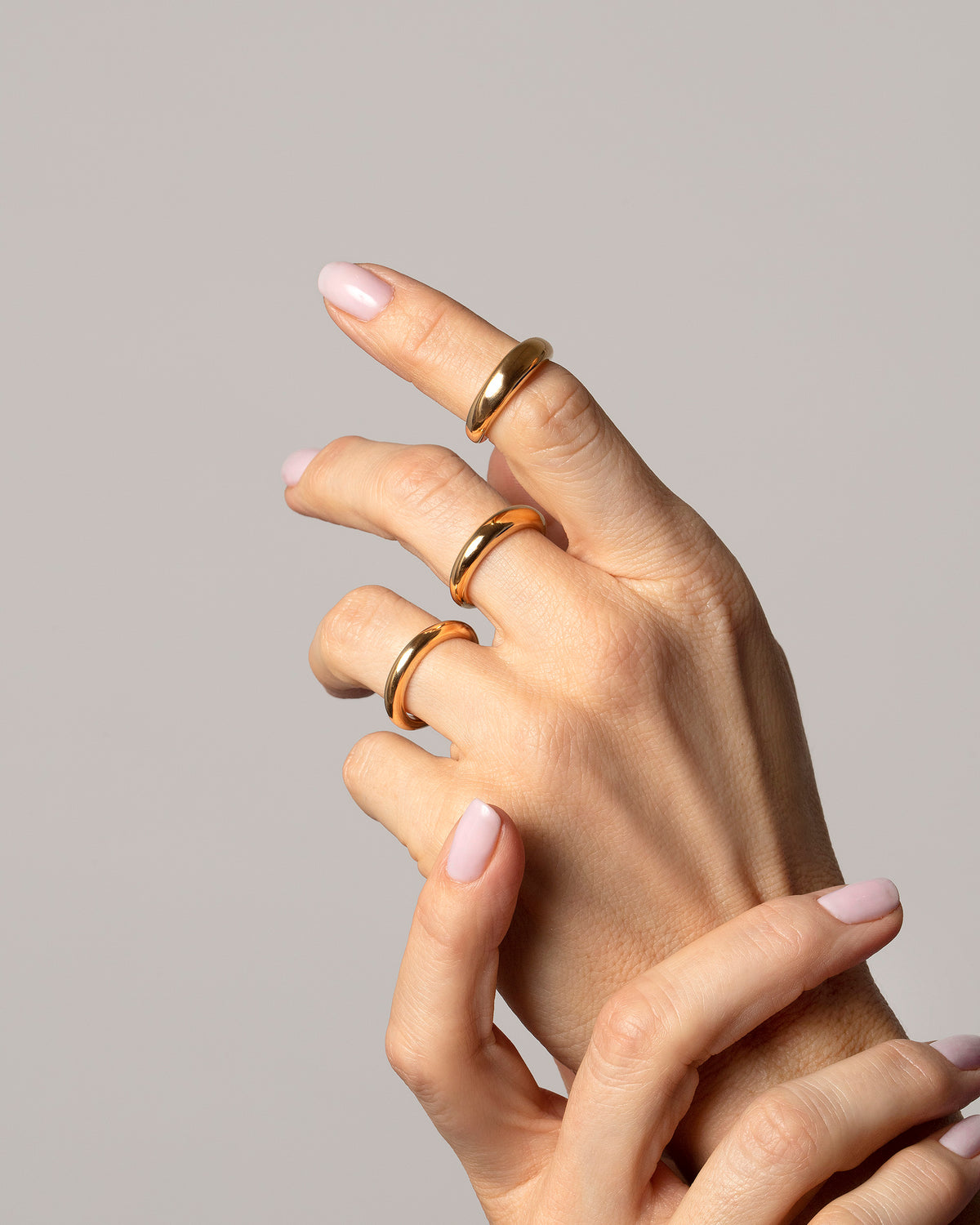 2.5mm,  4.5mm and 5.5mm Gold Venus Bands on model.