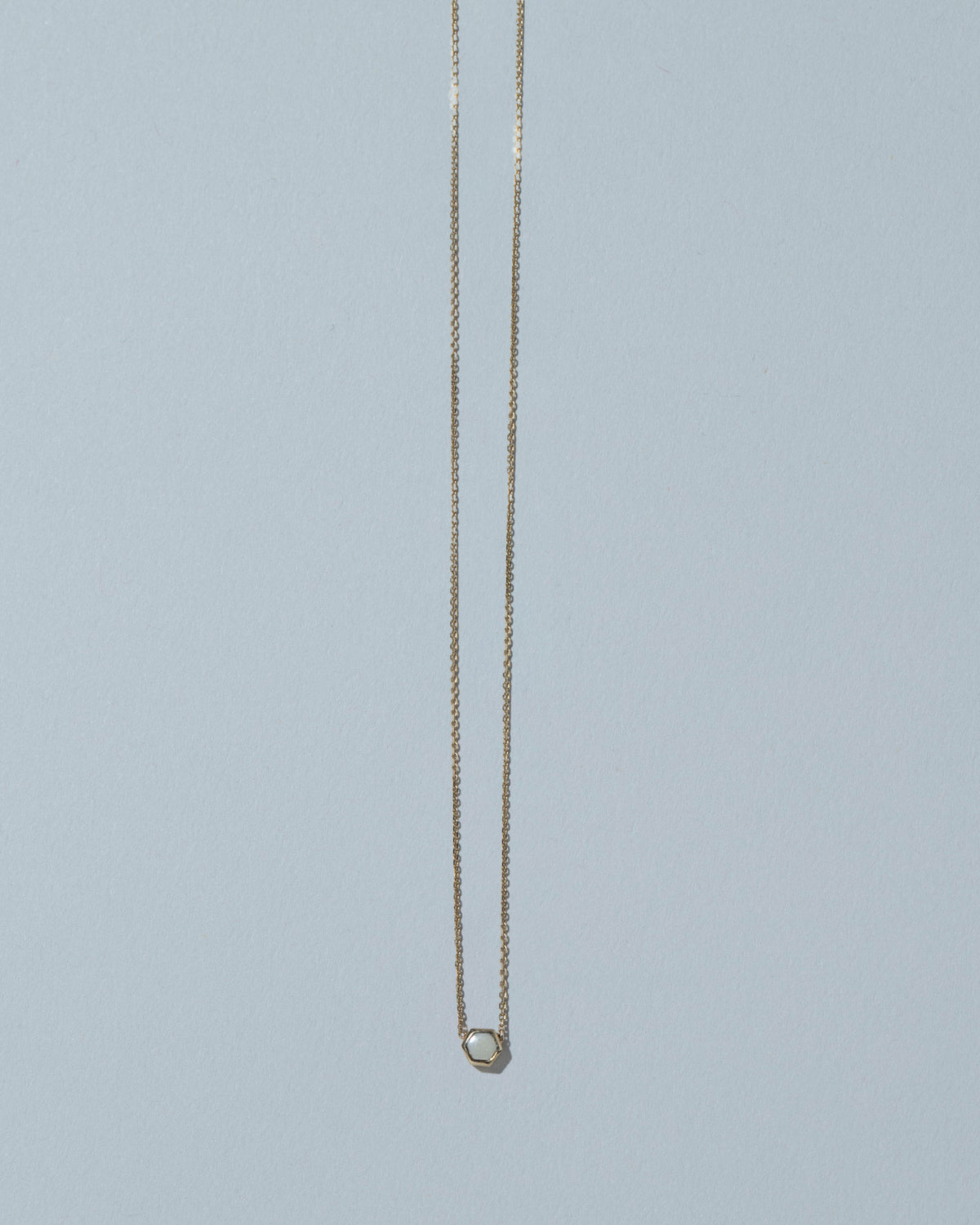 Snowdrift Agate Hexagon Necklace on light color background.