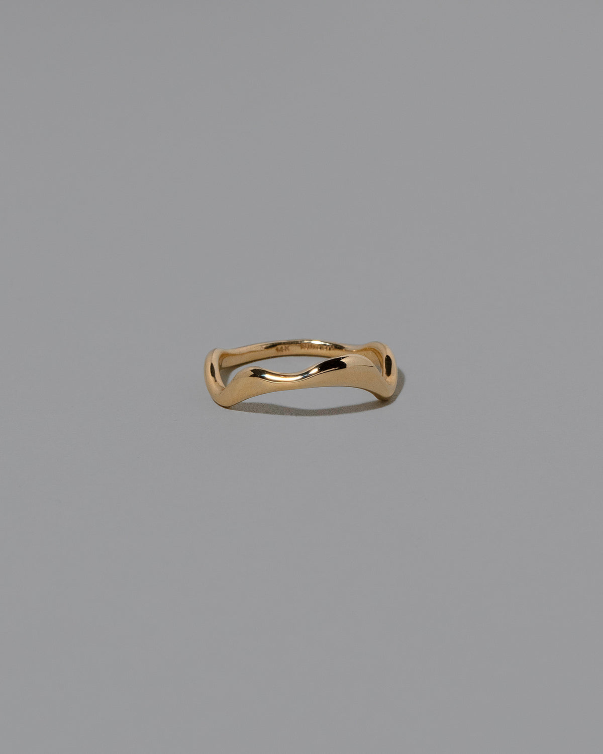 Gold Thin Fluctuating Band on light color background.