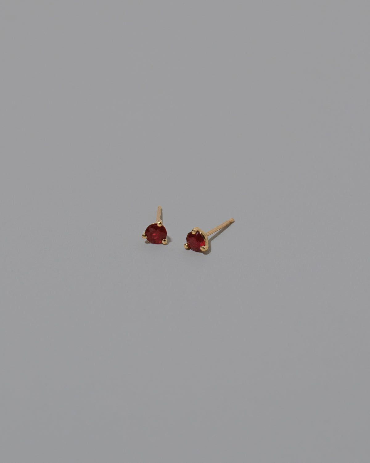 Magenta Ruby Martini Stud Earrings on light color background.
