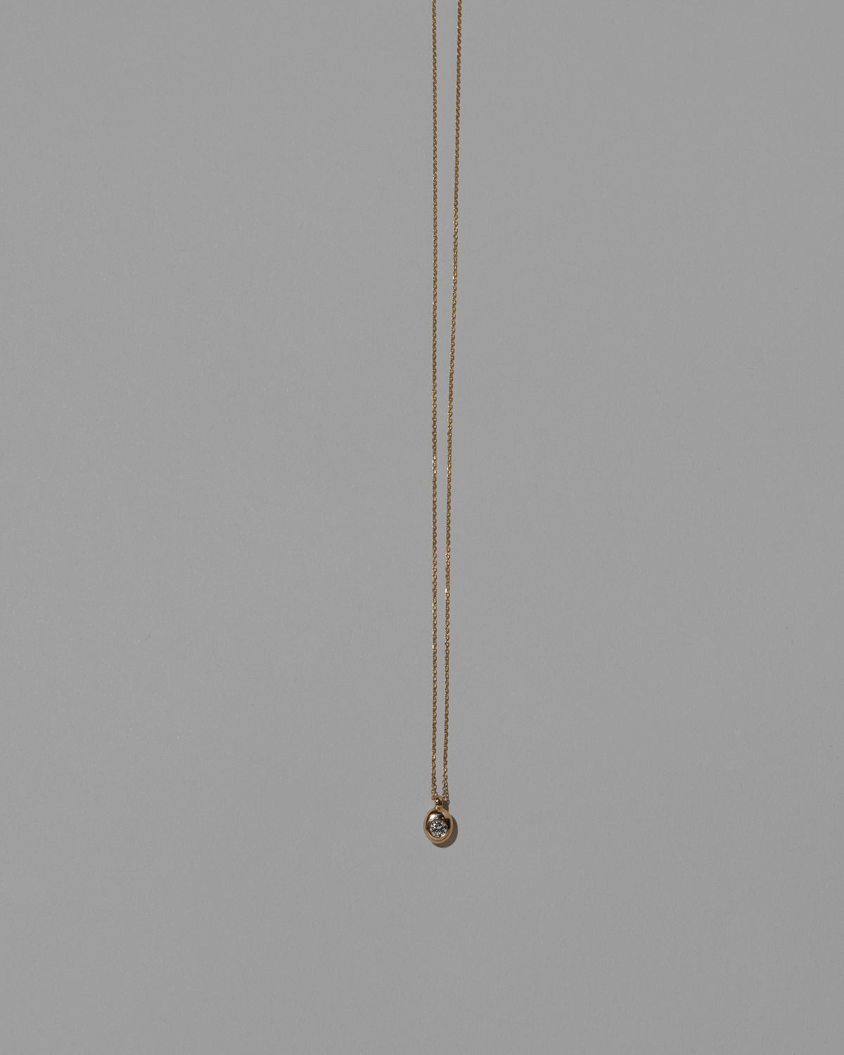 Diamond Birthstone Level Necklace on light color background.