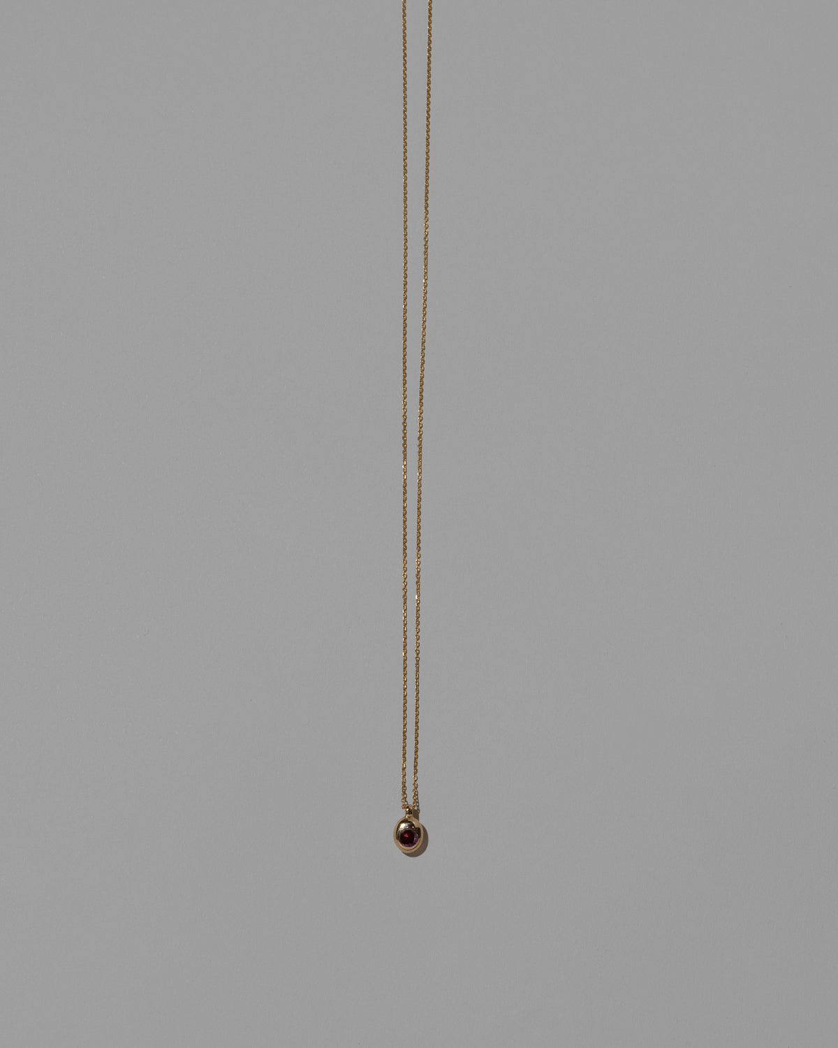 Ruby Birthstone Level Necklace on light color background.