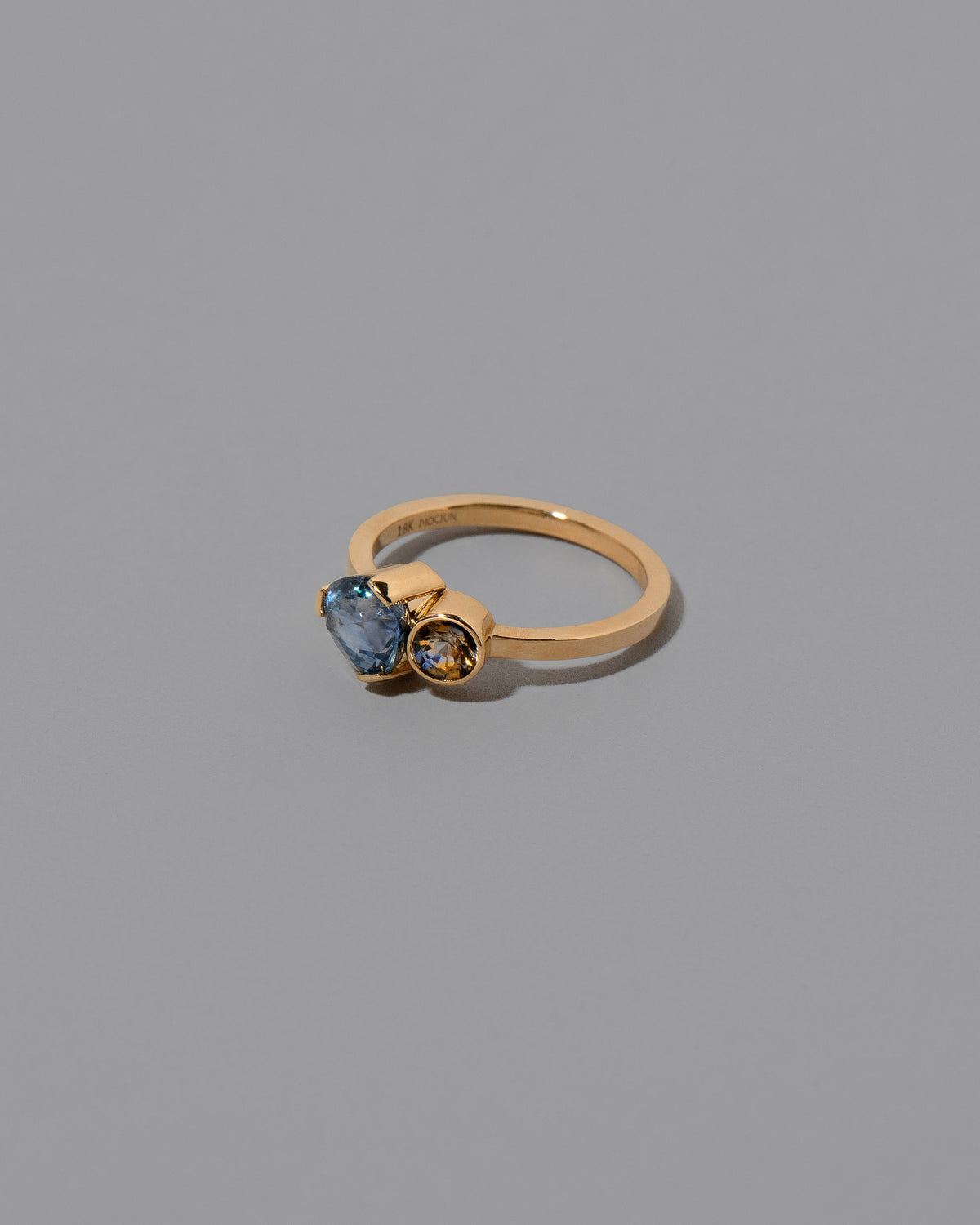 View from the side of the Plenitude Ring on light color background.