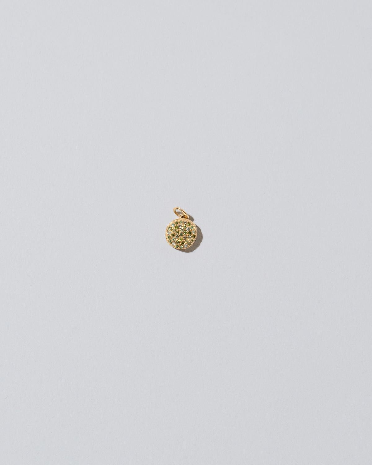 Mini Macaron Charm - Diamond Pavé Pistachio on light color background.
