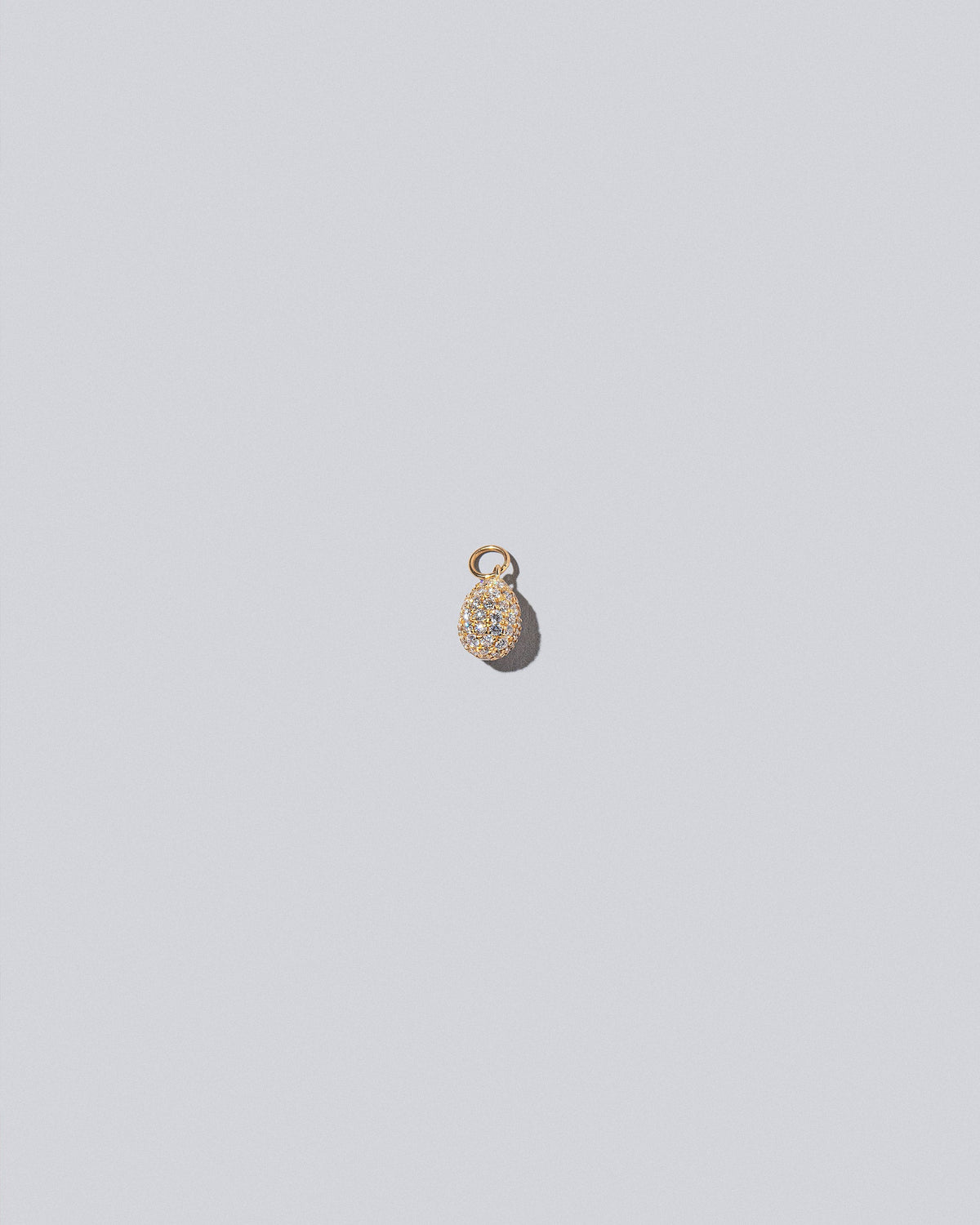 Pavé Blue Egg Charm on light colored background