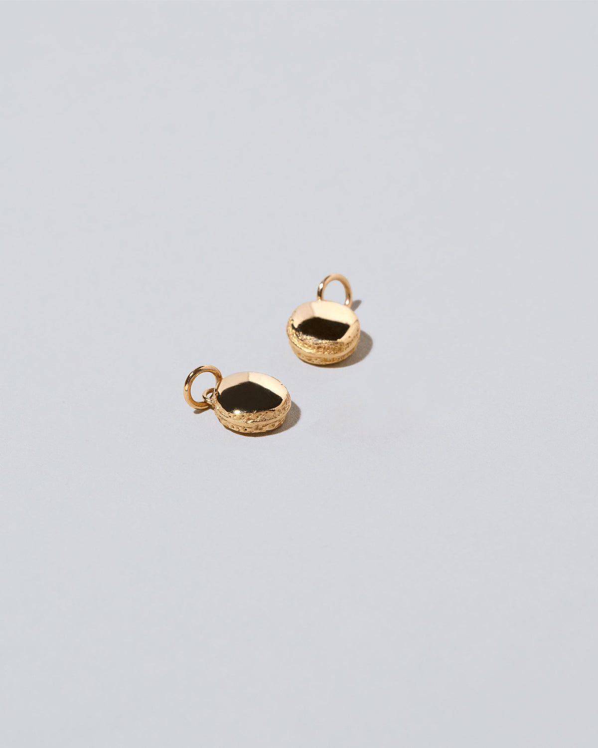 Mini Macaron Charm - 14k Gold on light color background.