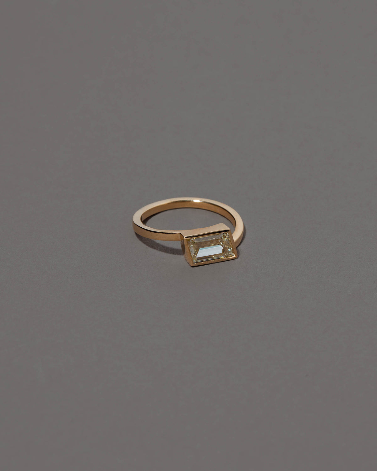 View from the side of the Jocundity Ring on grey color background.