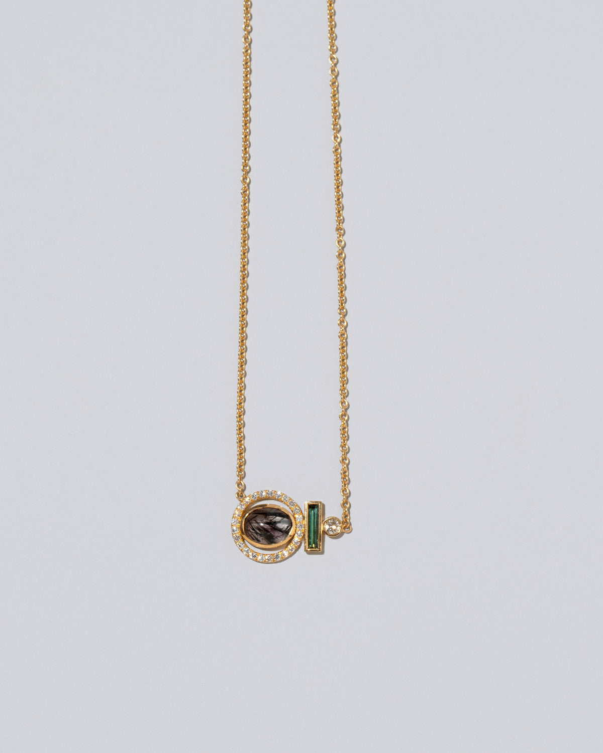 Closeup detail of the Mystical Change Necklace on light color background.