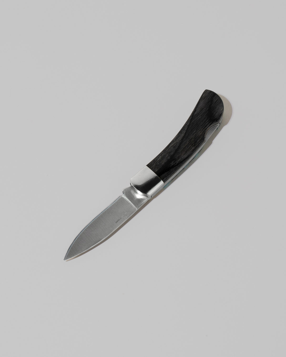 View from the back of the Small Lockback Knife on light color background.