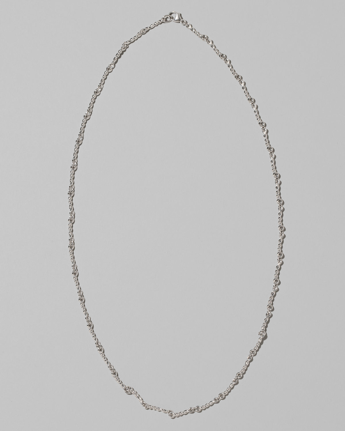 CRZM Sterling Silver Double Helix Chain Necklace on light color background.
